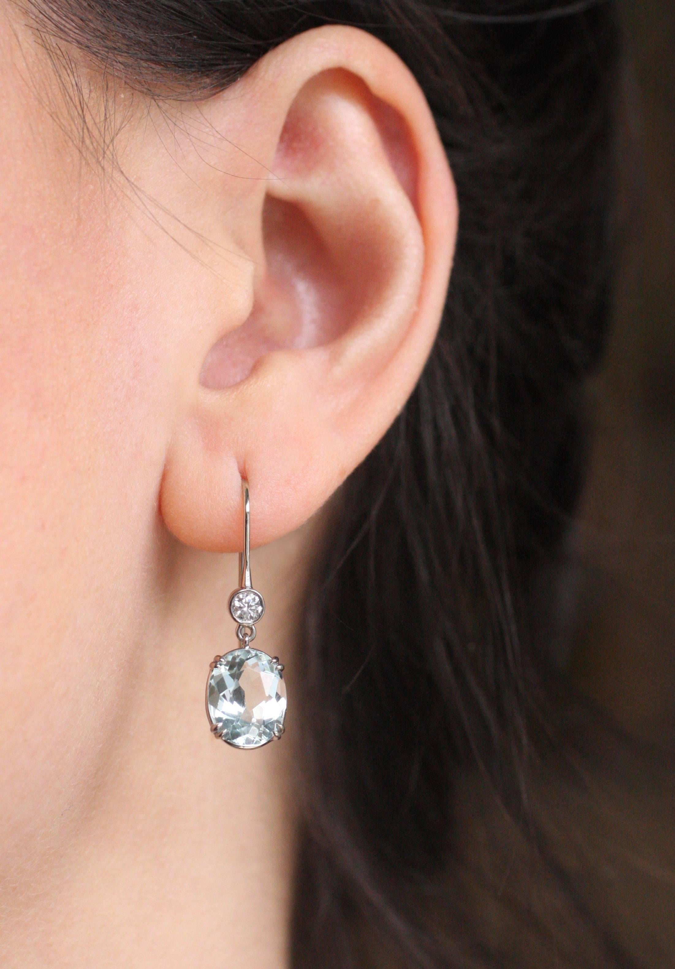 These lovely 18 Kt White Gold earrings contain two brilliant Diamonds and two oval Aquamarine drops (6.10 Carats).  Perfect for the Holidays!

Designed and made in house by Julius Cohen New York.