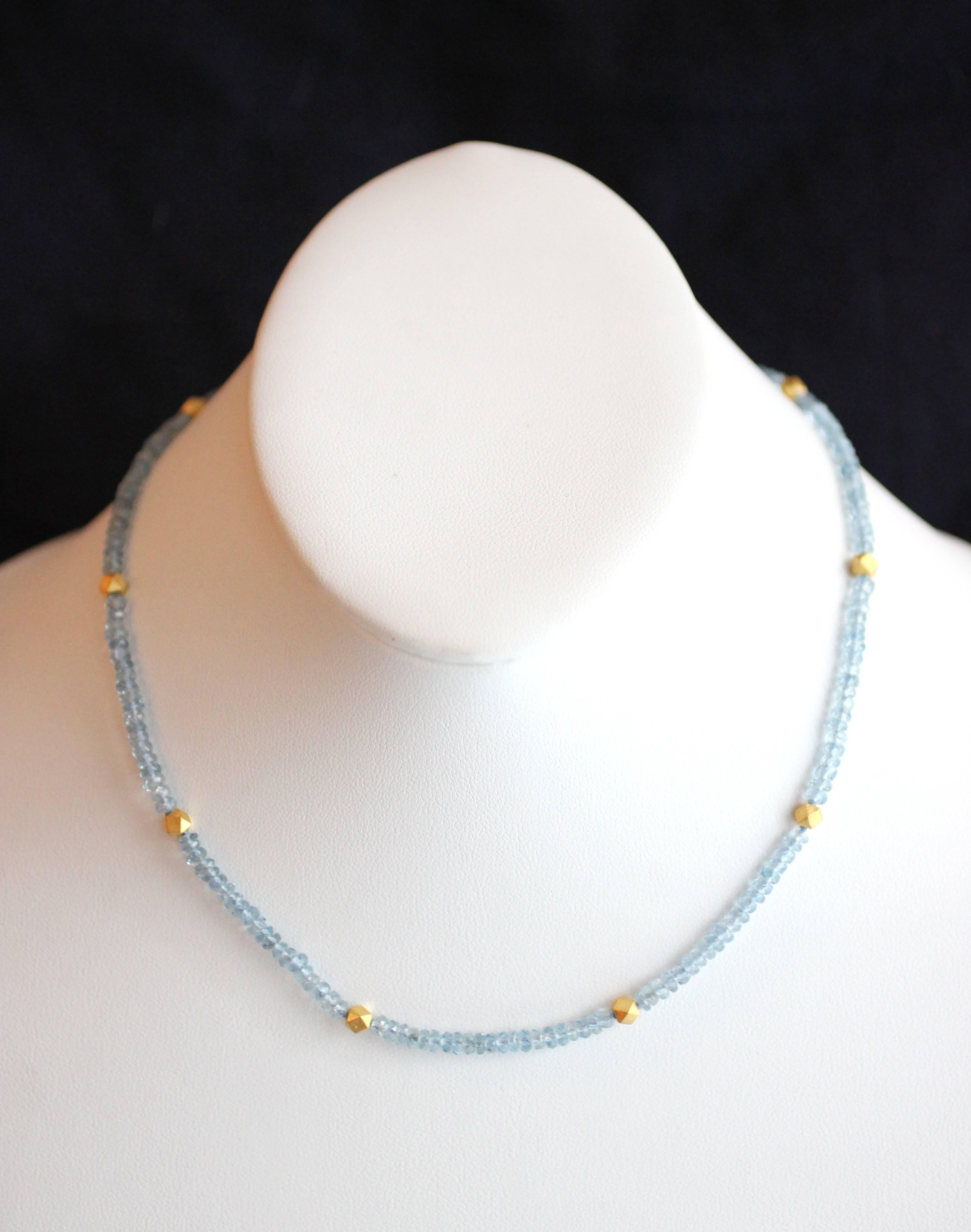 This beautiful and understated necklace contains approximately 37 carats of faceted Aquamarine beads punctuated by 24 Kt Gold Polyhedron Bead rondelles.  Closure is a classic Julius Cohen S-clasp, in 18 Kt Gold for added strength and durability. 