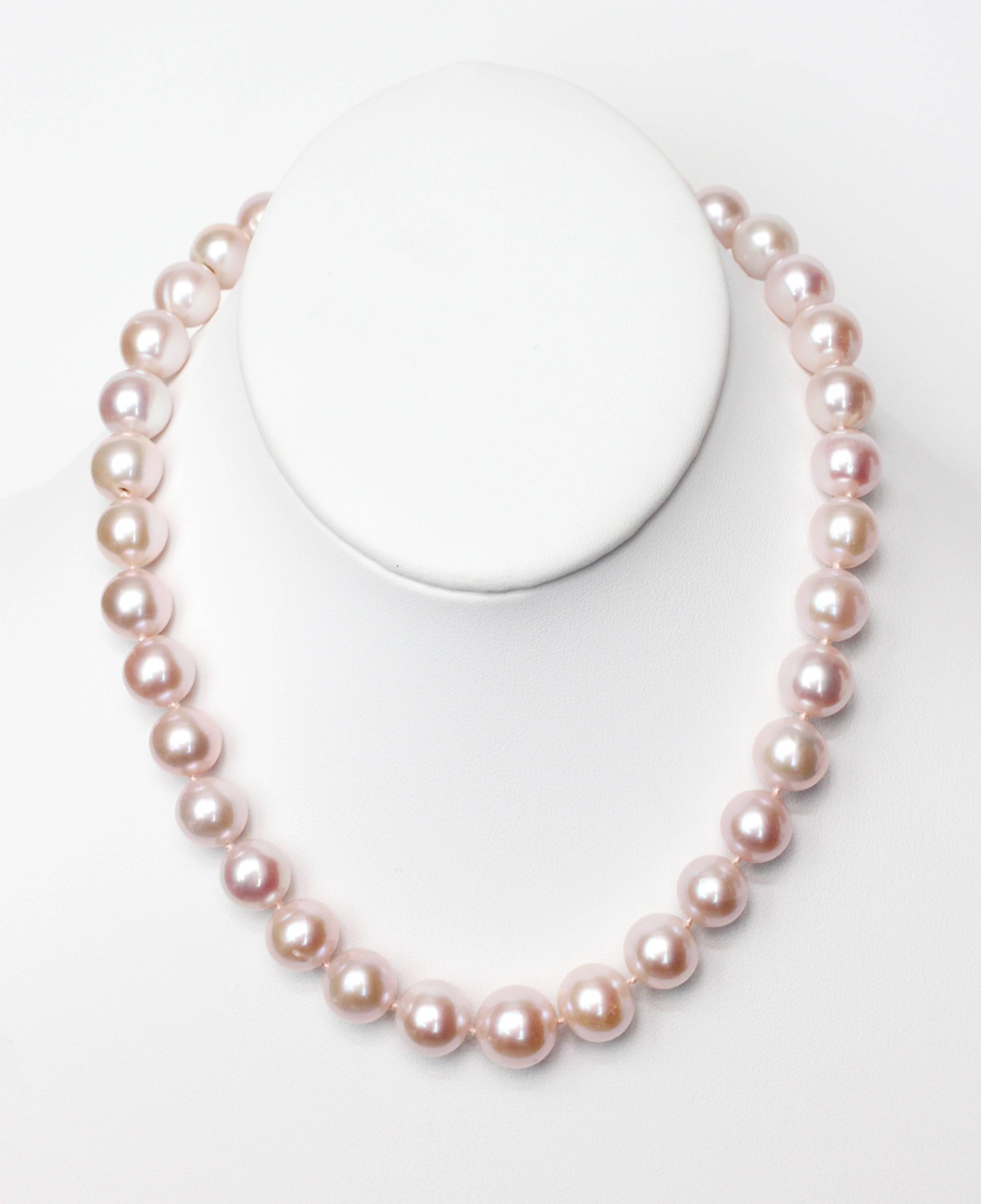 Knockout Pink Pearl single strand necklace containing 35 Fresh Water Pearls (11.2mm-12.6mm) with an 18kt Gold and Diamond ball clasp closure.  16 1/2" length.  Party time.

Designed and made in house by Julius Cohen New York.