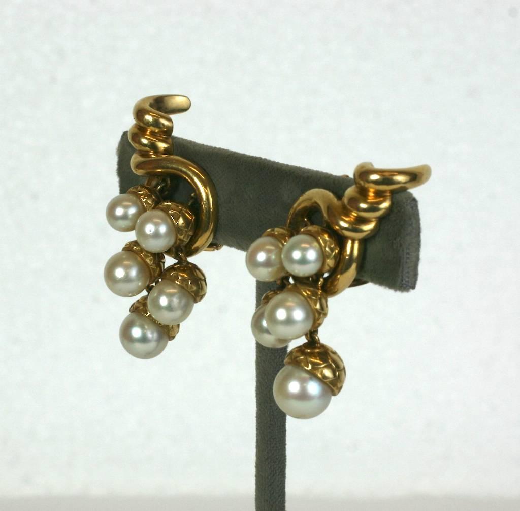 Charming French Pearl Acorn Cluster Earrings with clip back fittings, attributed to Rene Boivin who created the same style with diamond pave caps and pearls in platinum in the 1930's. 
Each cornucopia motif holds 5 cultured pearls of graduating