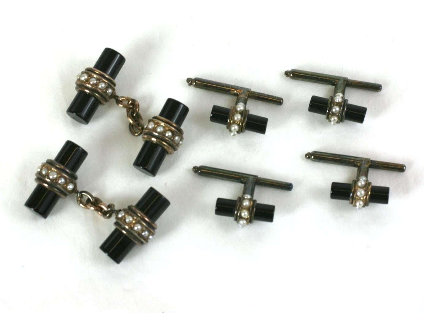 Unusual Art Deco Onyx and Pearl Stud Set, comprised of a pair of cufflinks and 4 shirt or vest studs. Deco onyx batons are set in vermeil sterling with a natural half pearl surrounds. Highly unusual mix of materials for the period. 1915-1920's USA.