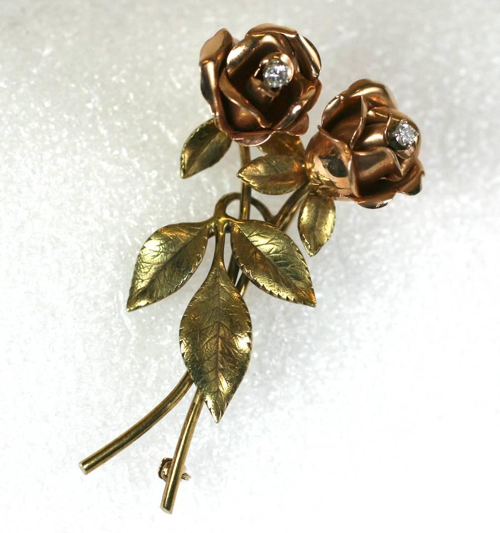 Elegant 2 Toned Rose Spray in 14k gold with diamond centers. Rose flowerheads are rendered in pink gold with green gold leaves and stems. Wonderful craftsmanship.
This particular design is attributed to Tiffany and Co. We have handled this design in