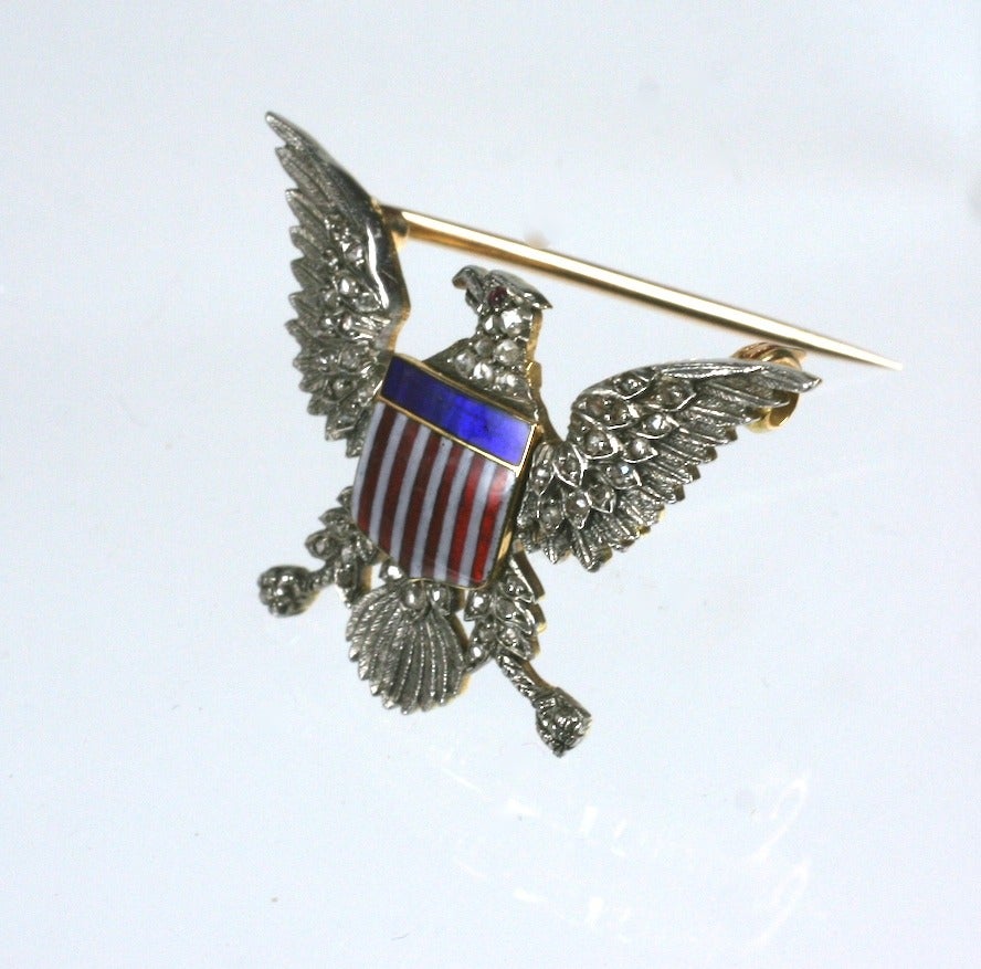 Antique eagle lapel brooch set in platinum topped gold with rose diamonds and enamel. Small but exquisite quality craftsmanship with ruby cab eye. 1910's USA. 1