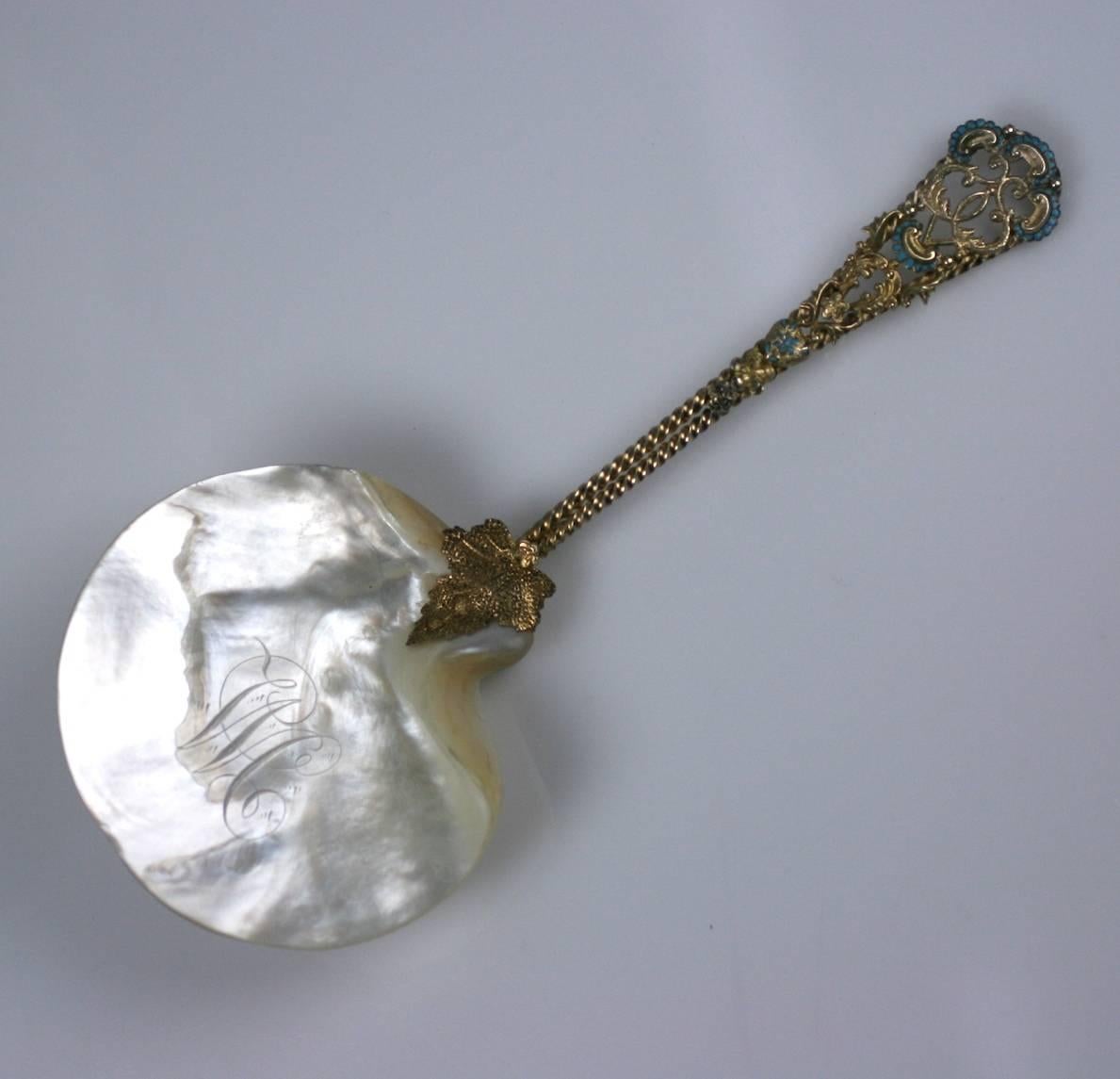 Victorian Sterling and Enamel Server made with mother of pearl. The handles and figural leaf hilt are gilt sterling with light blue enamel touches on handle. 
The Victorians had servers for every possible kind of food, many of which arent served