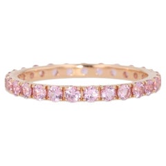 Bague « Eternity » en or rose 18 carats sertie de saphirs roses, signée Kimberly Collins 2 mm, 1,10 ct au total