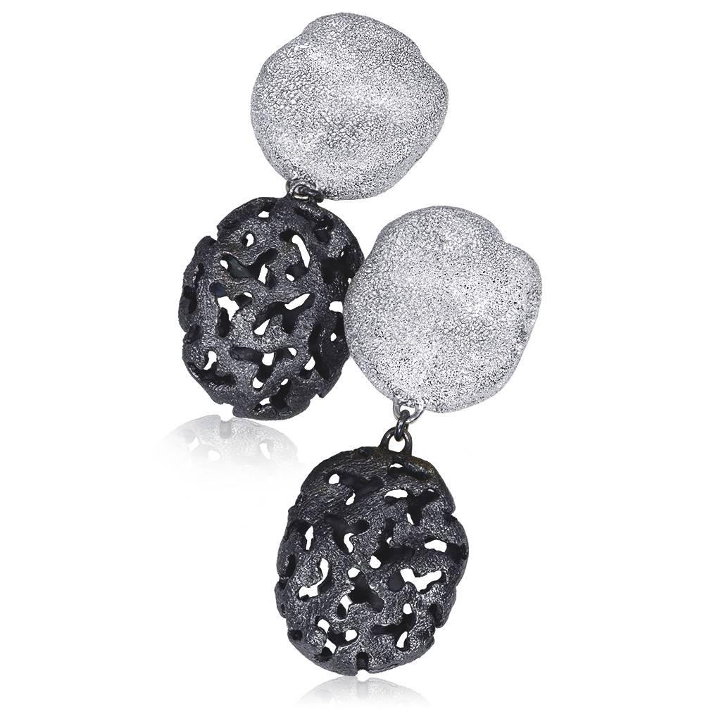 Alex Soldier Moneta Earrings made in silver with platinum (rhodium) infusion (deep plating) and signature metalwork that creates an illusion of a diamond inlay. Handmade in NYC. $550.   

Key Facts About The Artist: Known for his elaborate