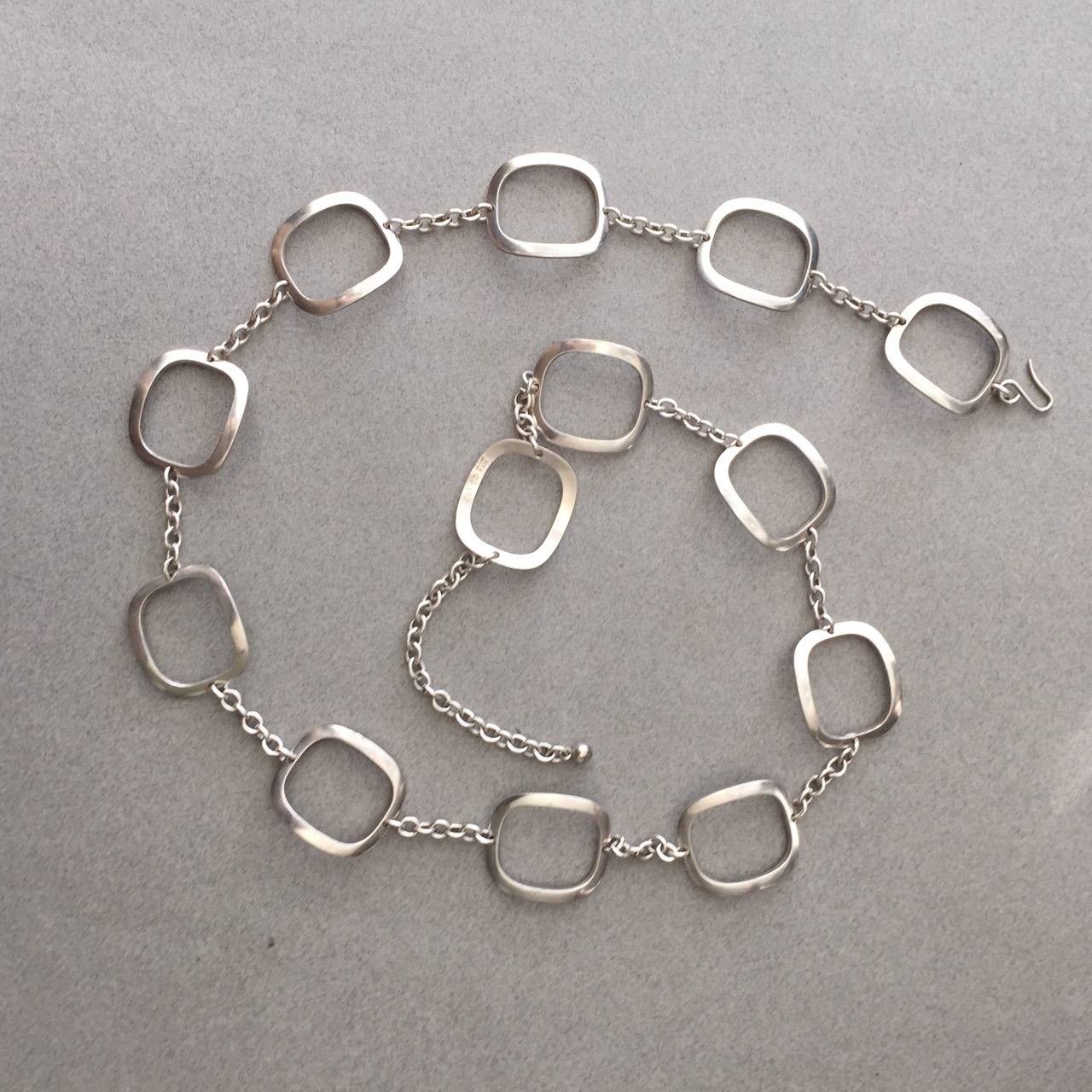 Georg Jensen sterling silver modernist belt no. 192 designed by Ibe Dahlquist. Sterling silver, circa 1970's. Comprised of 13 rectangular domed handmade links. 33" total length. Hook clasp. Matching necklace is also available. 

Excellent