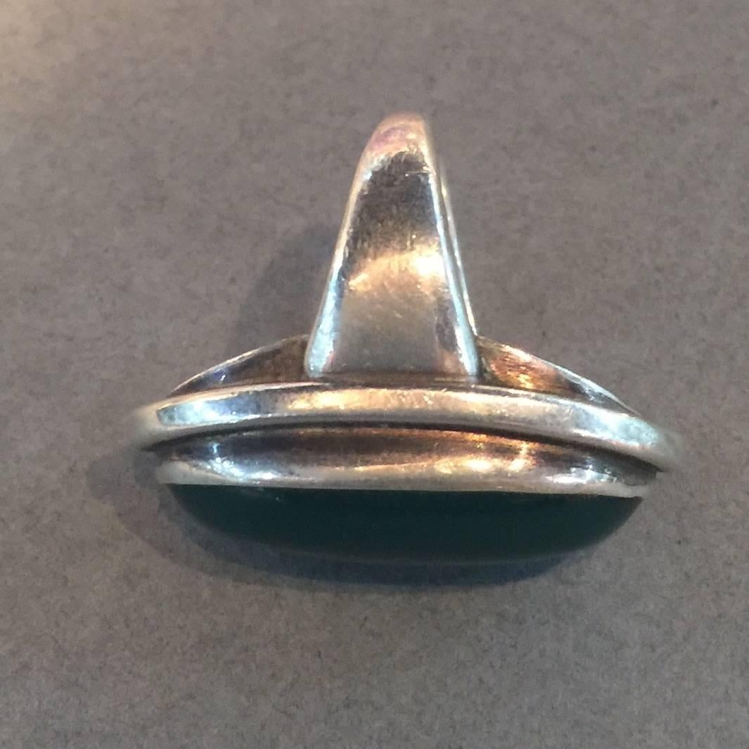 Georg Jensen Sterling Silver Green Agate Ring No. 46E by Harald Nielsen.

This is the largest size of this design and it can be sized at no charge.

This is a stunning ring with a vivid, large stone in excellent condition. 

Face of ring: