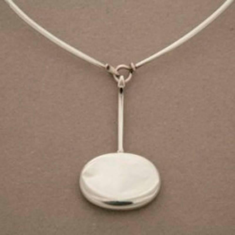 Georg Jensen Sterling Silver Pendant No. 304 by Vivianna Torun with No. 174 Sterling Silver Neck Ring. 

Circa 1970s and from original production.

Excellent vintage condition. Neck ring included in price. 

A similar example can be seen in