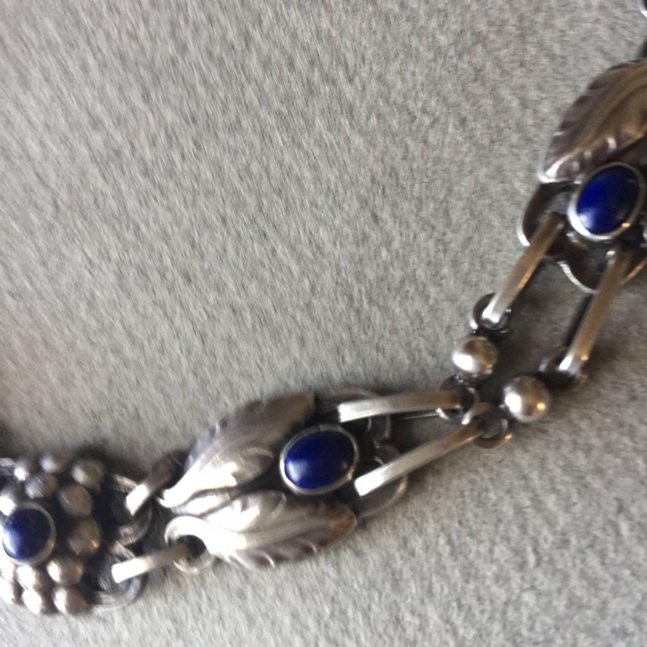 Georg Jensen Sterling Silver Necklace No. 1 with Lapis Lazuli.

Designed by Georg Jensen in 1904, this stunning piece has hallmarks from 1933-44.

This necklace is articulated beautifully so that it lays perfectly on the neck and breastbone. This