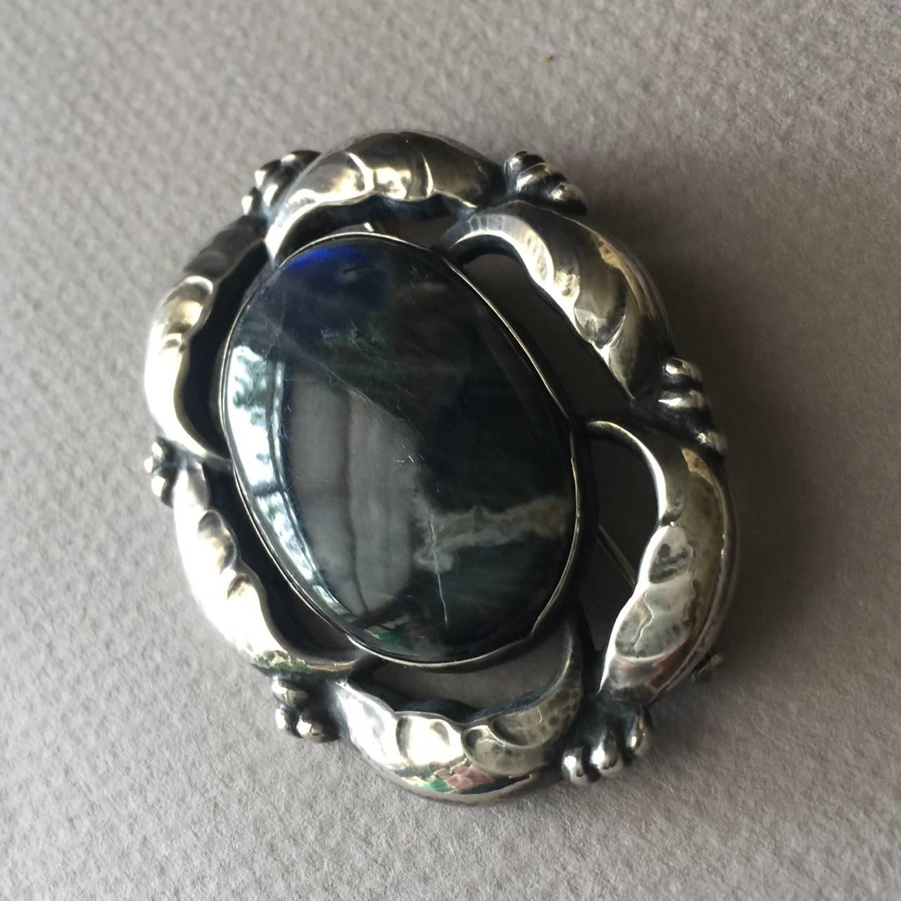 Georg Jensen Sterling Silver Brooch No. 130 with Labradorite

Amazingly beautiful sterling silver brooch with a large, gem quality labradorite gemstone surrounded by sterling silver from Denmark. The labradorite looks like the planet Earth, with