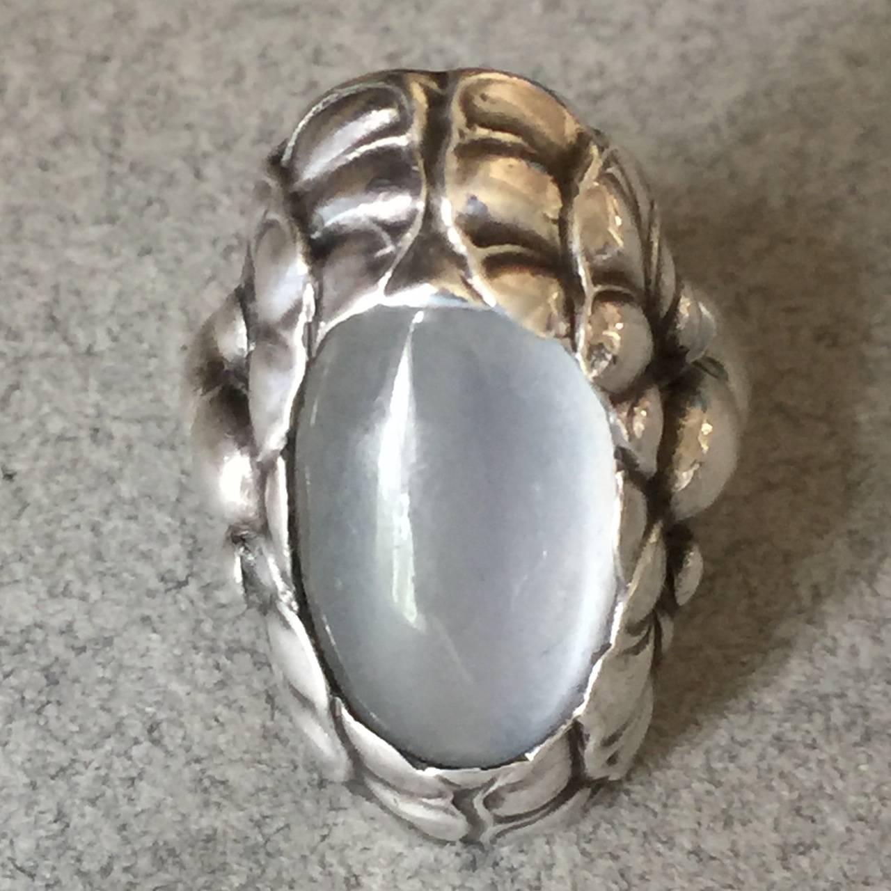Georg Jensen Sterling Silver Ring No. 11 with Moonstone

Rare to see in this large size. Gorgeous moonstone is large oval and is surrounded by an oak leaf pattern setting. 

Excellent condition.

Size 5.75