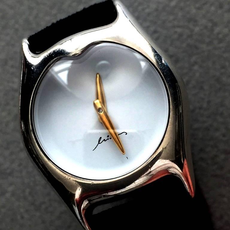 Georg Jensen Sterling Silver Watch by Minas Spiridis.

Rare. This is one of a limited edition of 1000. The case is Sterling Silver and Swiss made with the Minas signature. Watch hand is 18K gold. Watch Chrystal is hard sapphire glass. The new band
