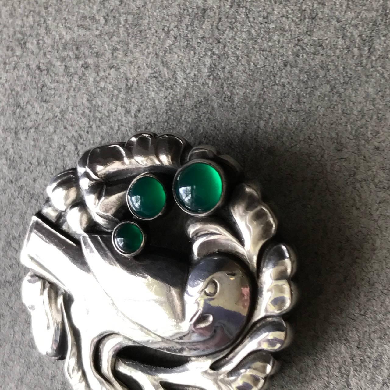 Georg Jensen Dove Brooch No 134 designed by Kristian Mohl-Hansen.

Bright Green Agate Cabochons. Excellent condition.

This is the smaller size of this design.

Complimentary gift box and FREE shipping included.
