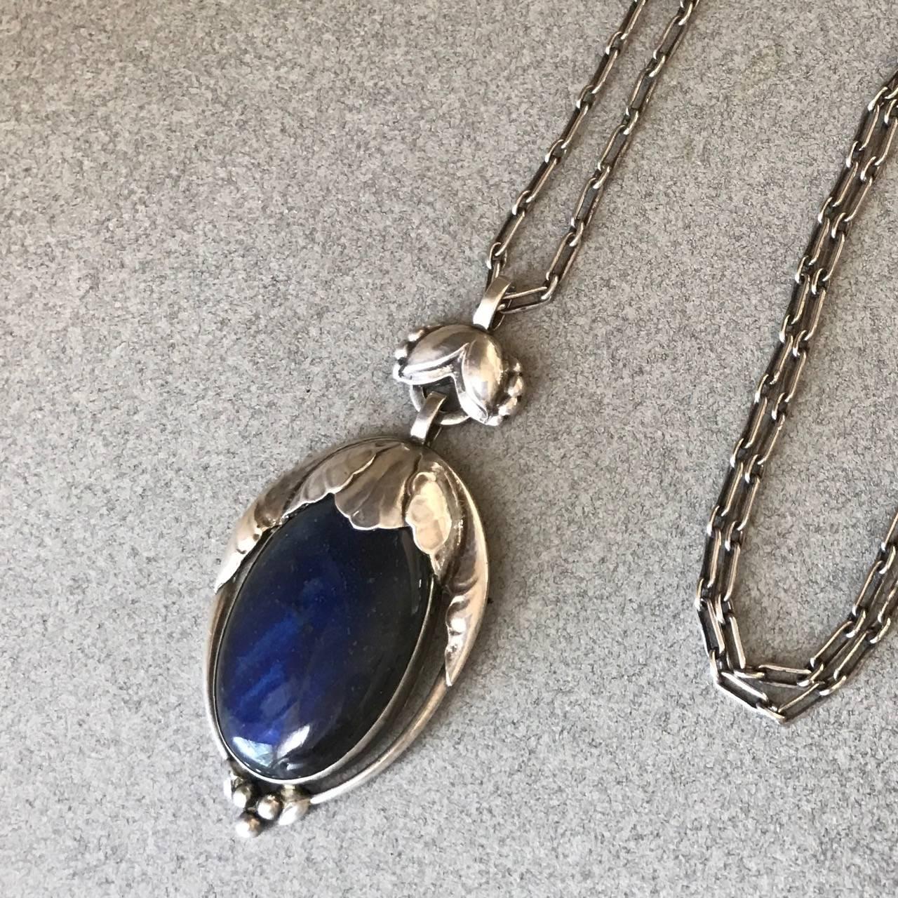 Georg Jensen Large 830 Silver Pendant No 54 With Labradorite, Very Rare.

Exceptional detail and gem quality labradorite with deep iridescent blue. 

32 inch  Handmade Paperclip chain with toggle clasp.

