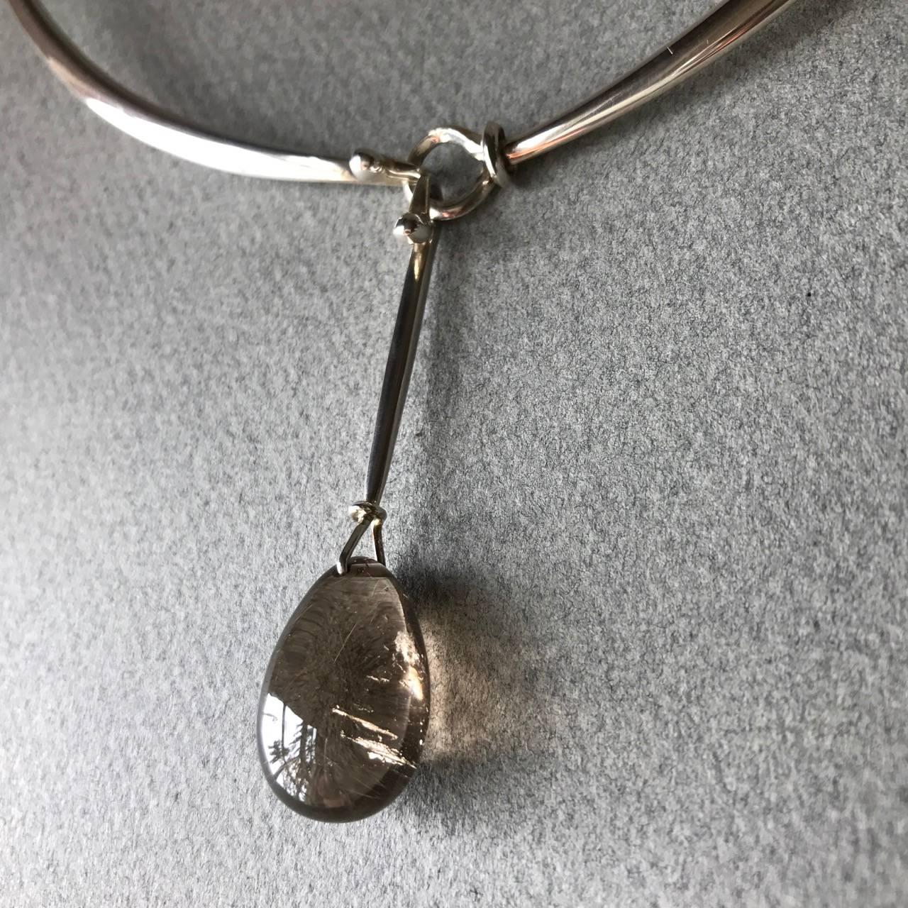 Georg Jensen Neck Ring No 410 With Rutilated Quartz Drop No. 128

Beautiful natural rutilated gold threads enhance this smokey quartz drop on a round shaped neck ring.

Elegant, timeless design.

Comes with original Georg Jensen presentation