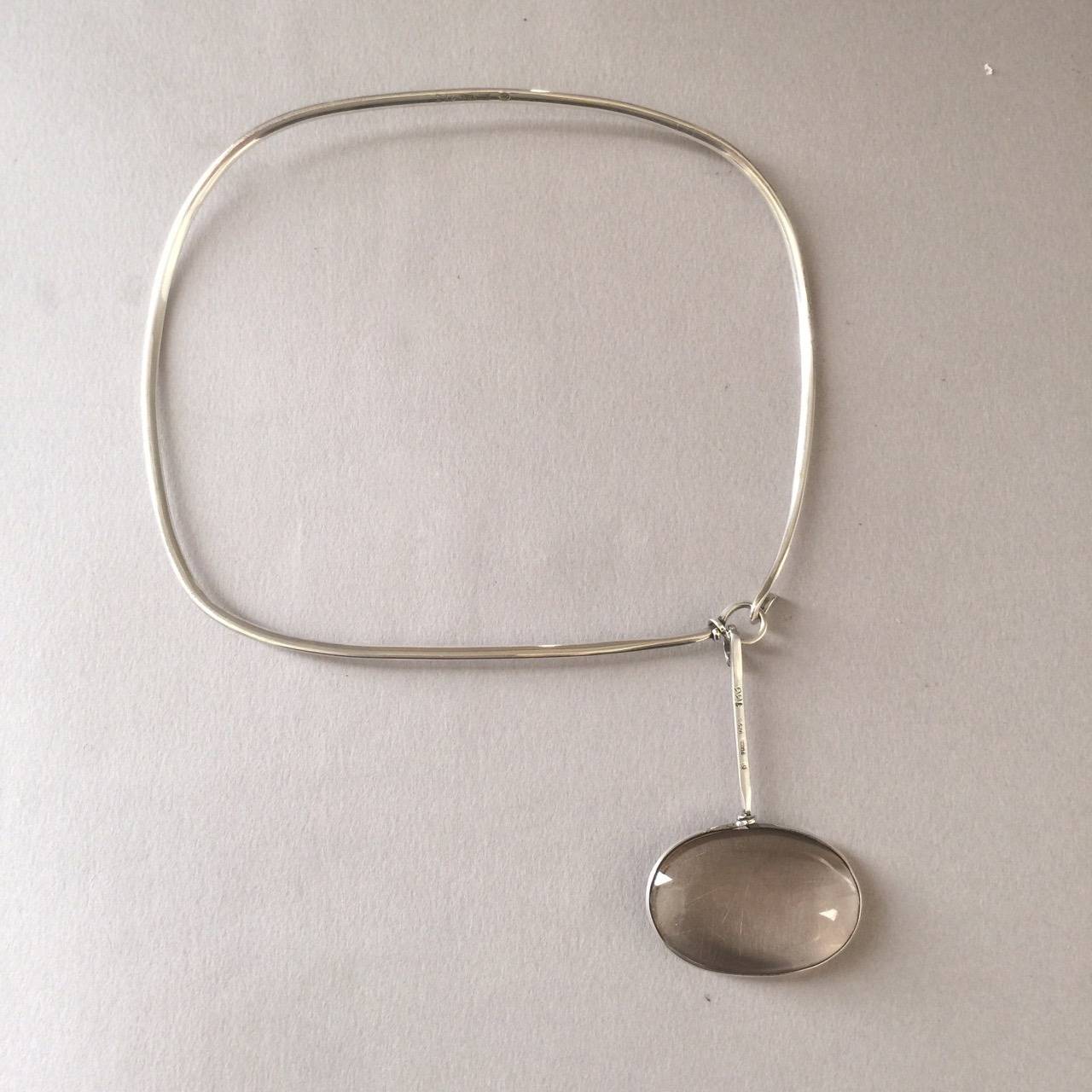 Georg Jensen Neck Ring No. 133 With Rutilated Quartz Drop No. 173 By Vivianna Torun.

Torun's classic innovative design and sculptural form are highlighted in a unique square neck ring and off centered drop. Circa 1970. Sterling silver.

6