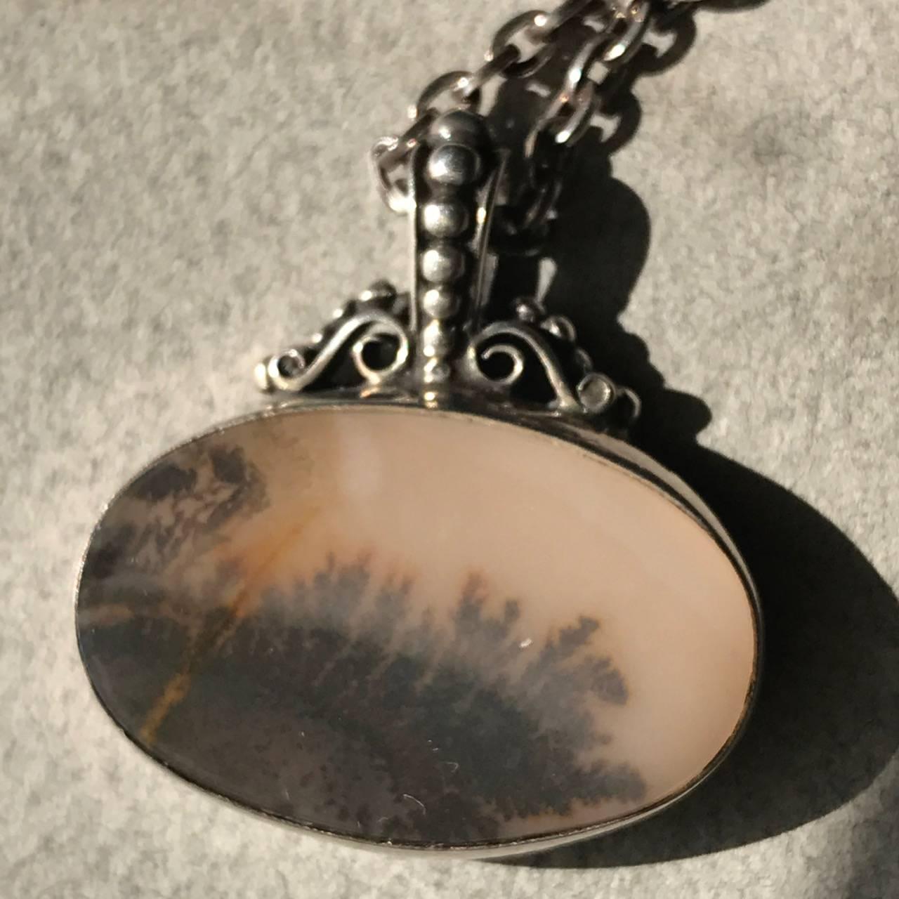 Royal Copenhagen Sterling Silver and Landscape Agate Necklace

Sterling silver bezel featuring a charming landscape agate highlighting warm earth tones.

Made as a limited edition in the 1980's.

Complimentary gift box and FREE shipping included.