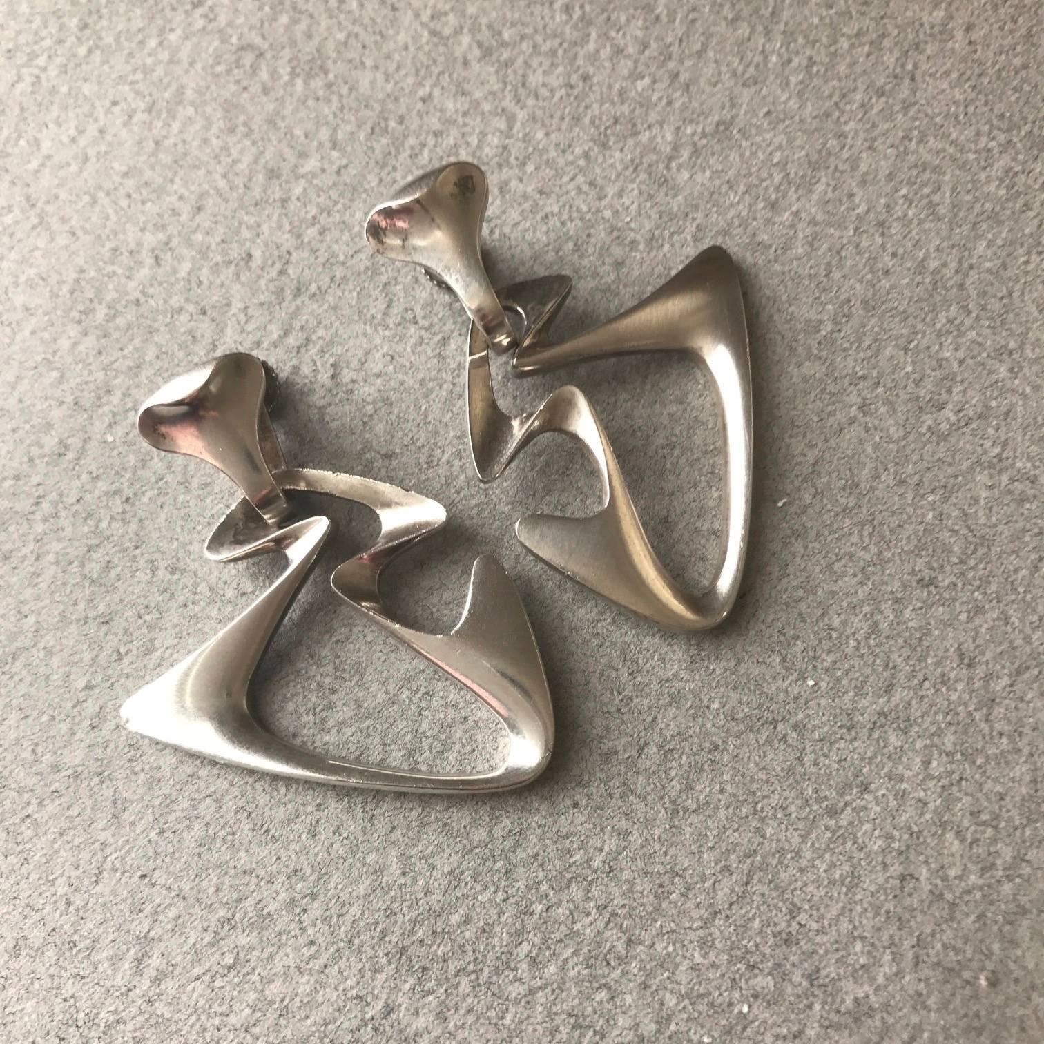 Georg Jensen "Amoeba" Dangle Earrings by Henning Koppel, no. 125
 

Dramatic and highly sculptural with screw-backs clasps.

A similar example can be seen in the book, GEORG JENSEN JEWELRY by Isabelle Anscombe, edited by David A. Taylor.