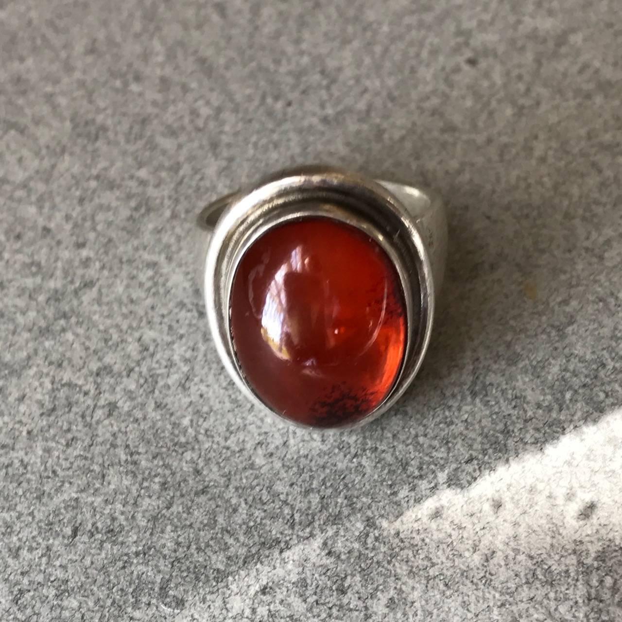 Georg Jensen Sterling Silver Amber Ring by Harald Nielsen, No. 46A

A classic sterling silver ring featuring a bright translucent amber cabochon.

Post 1945 Hallmarks.  Size 7.

Can be resized up or down. Very good condition.

Complimentary gift box