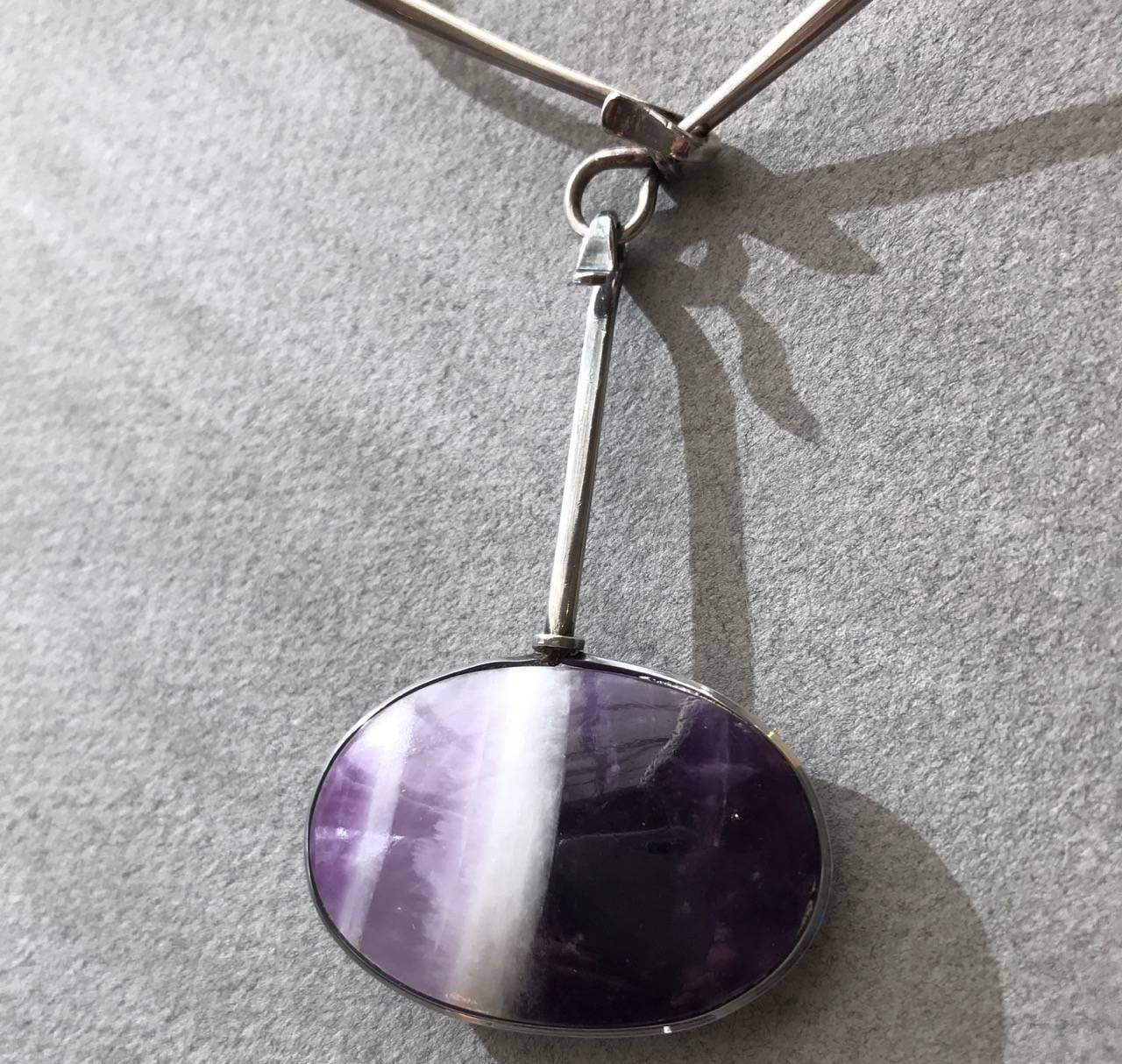 Georg Jensen Sterling Silver Neckring with Amethyst drop No. 133/174 By Vivianna Torun 

Complimentary gift box included with purchase.
Additional Drops are available, please inquire.

A similar example can be seen in the book, GEORGE JENSEN JEWELRY