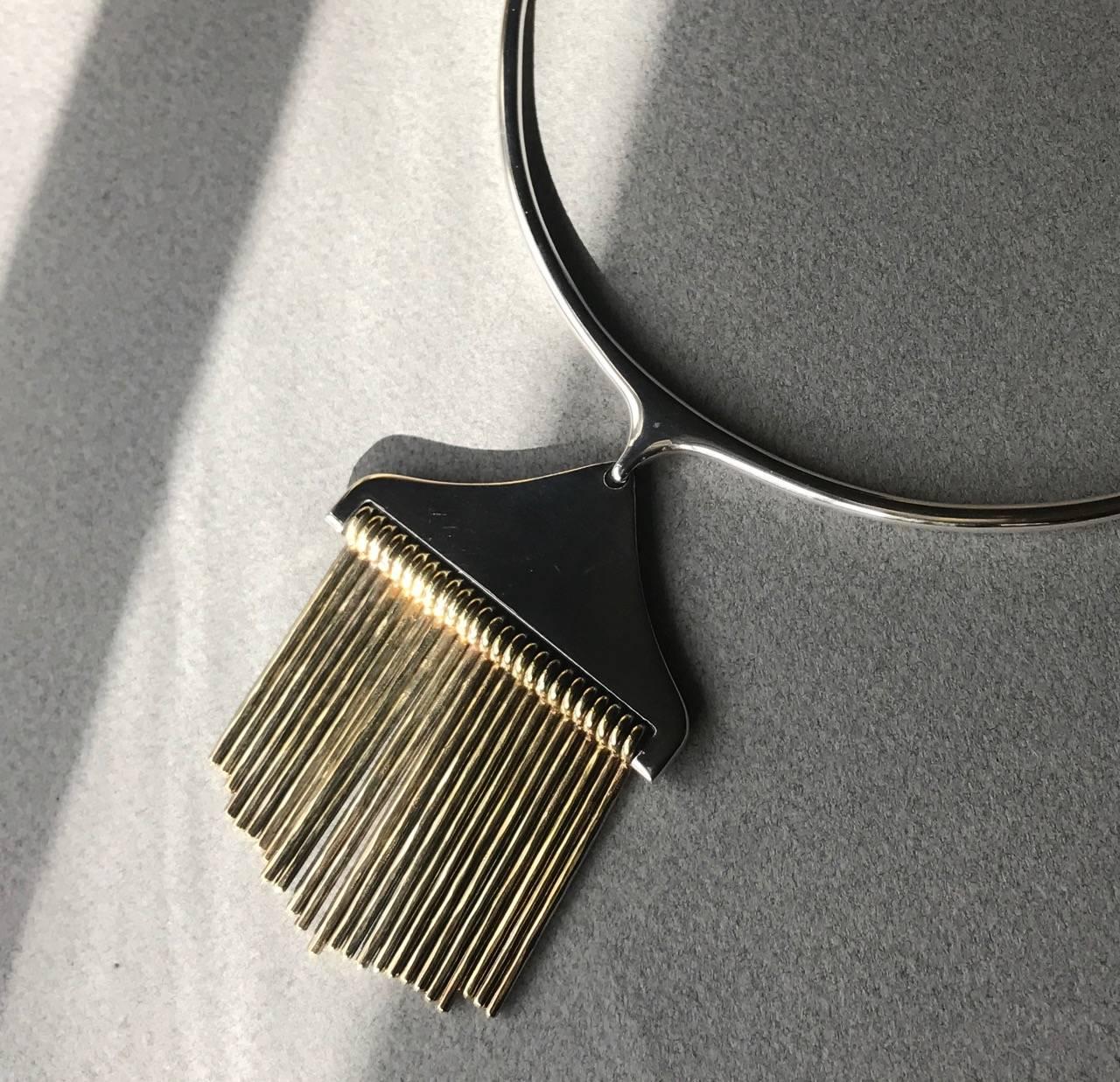 Hans Hansen Sterling Silver Necklace With Pendant By Bent Gabrielsen.

Pendant has Gold Gilt hand Hammer bars and Necklace has smooth sterling hinged bars and toggle clasp for comfortable wear.
This rare design can be seen in the permanent