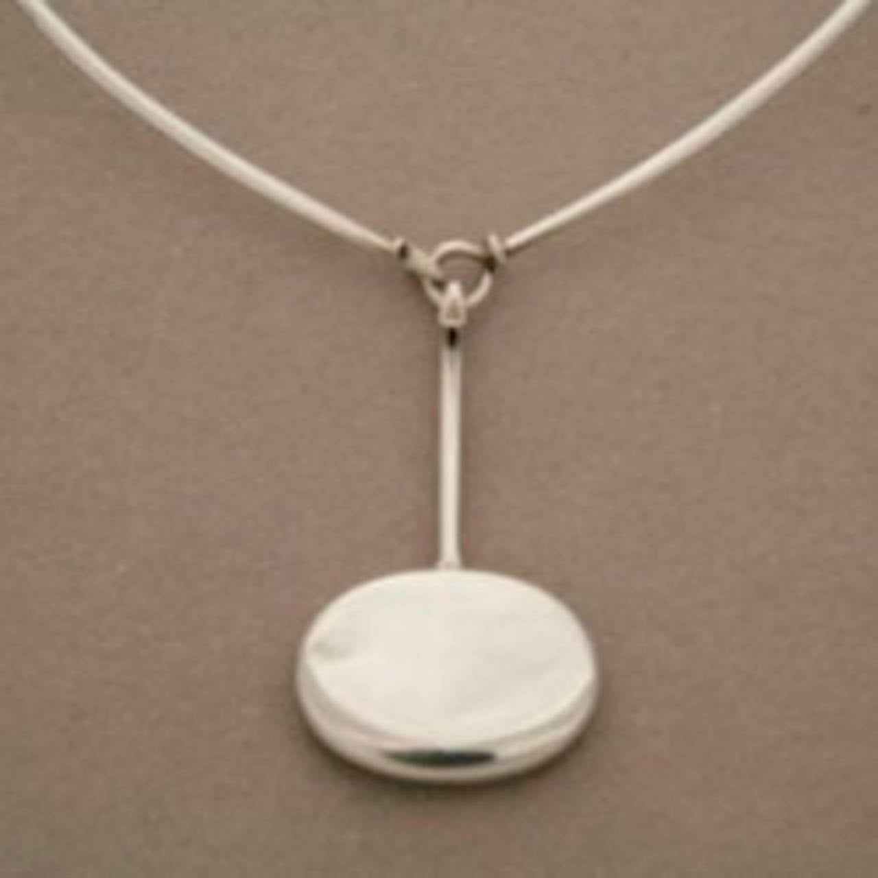 Georg Jensen Sterling Silver Pendant No. 304 by Vivianna Torun with No. 174 Sterling Silver Neck Ring. 

Circa 1970s and from original production.

Excellent vintage condition. Neck ring included in price. Can be interchanged with neck ring No.