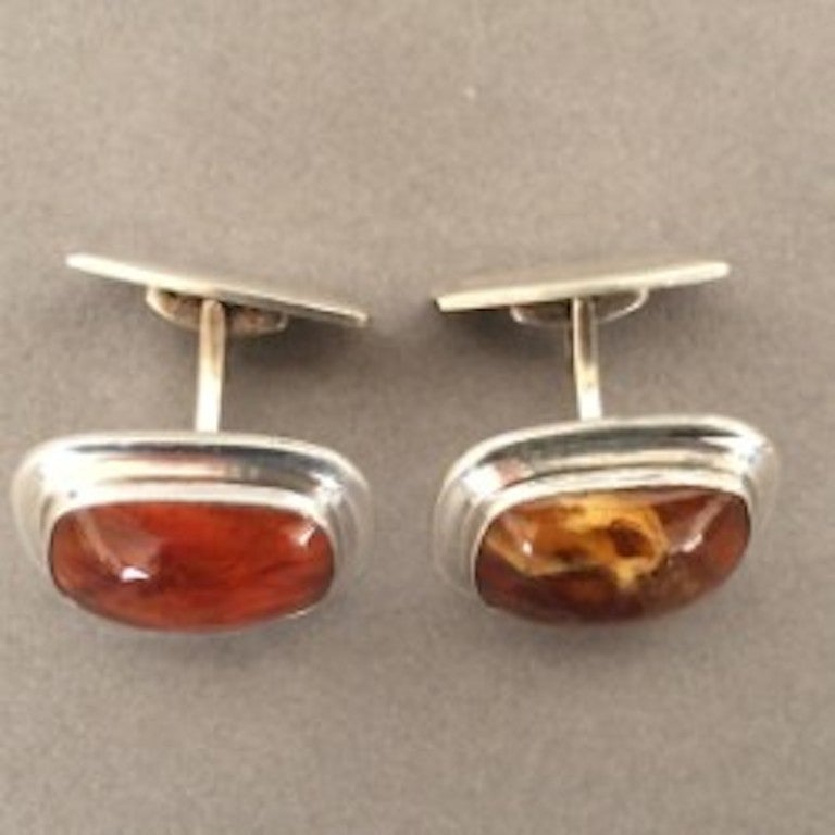 Danish Modernist Cufflinks with Amber by Einer Fern.

Pair of 835 Silver Modernist Cufflinks from Denmark with Amber Cabochon. c.1960's

Dimensions: .8