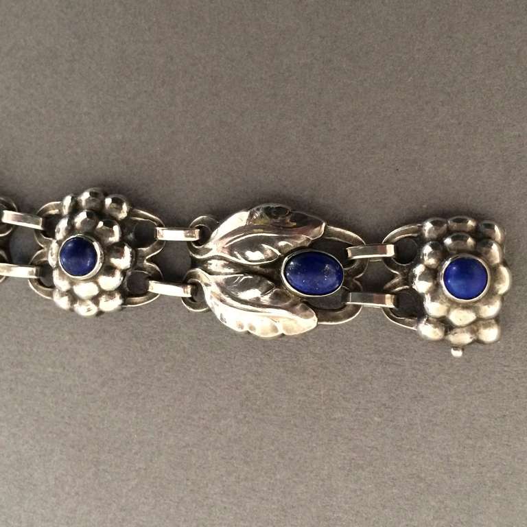 Georg Jensen Bracelet No 3 with Lapis Lazuli

One of Georg Jensen's first designs.
This is an early example with Lapis Lazuli cabochons and hallmarked from 1933-44. Excellent condition and patina.

Georg Jensen grew up in a small village