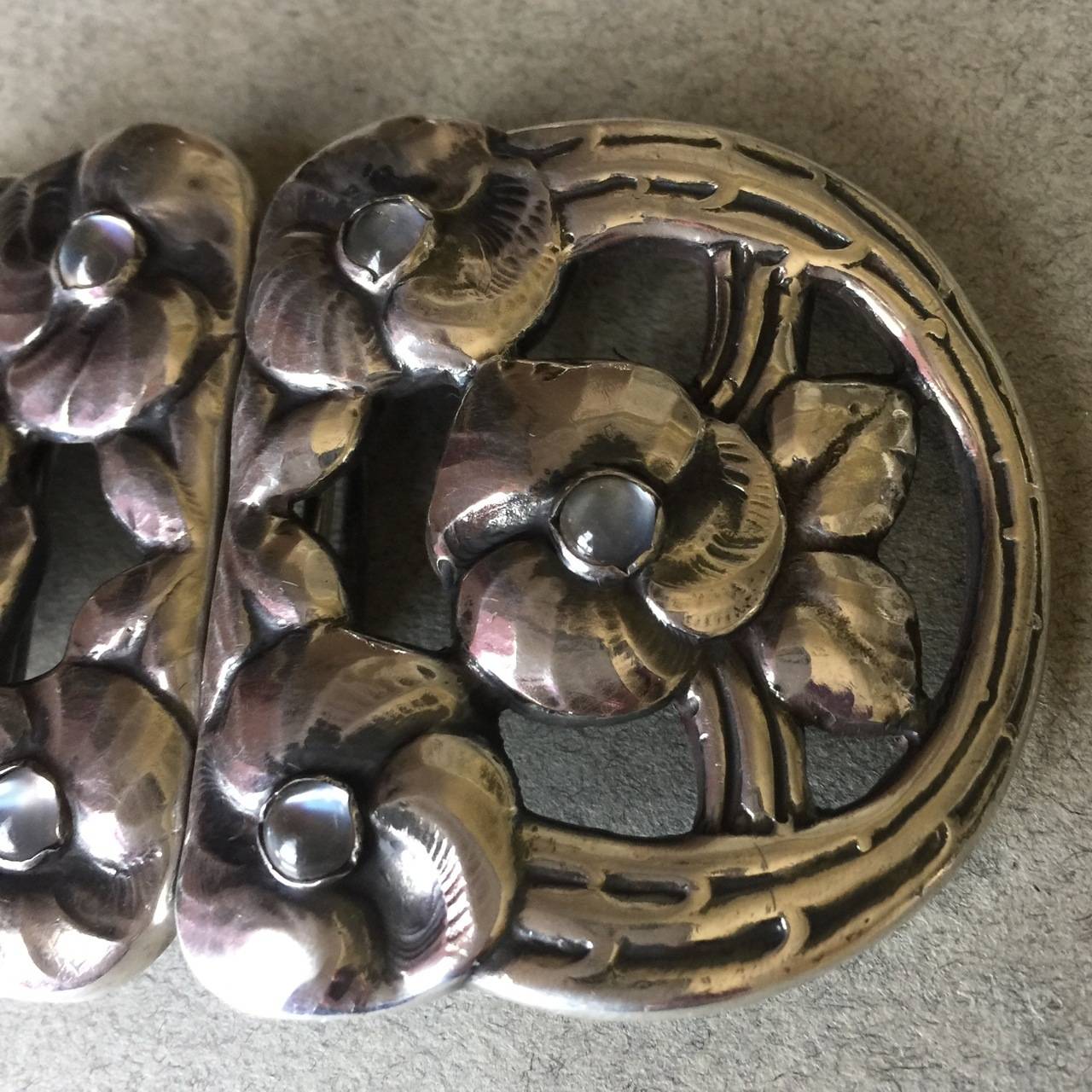 Evald Nielsen Rare Belt Buckle with Moonstones

Evald Nielsen .830 silver belt buckle designed with six lovely flowers with a bright, lively moonstone in the center of each.   

This rare find was produced in the 1920's. It is in excellent condition