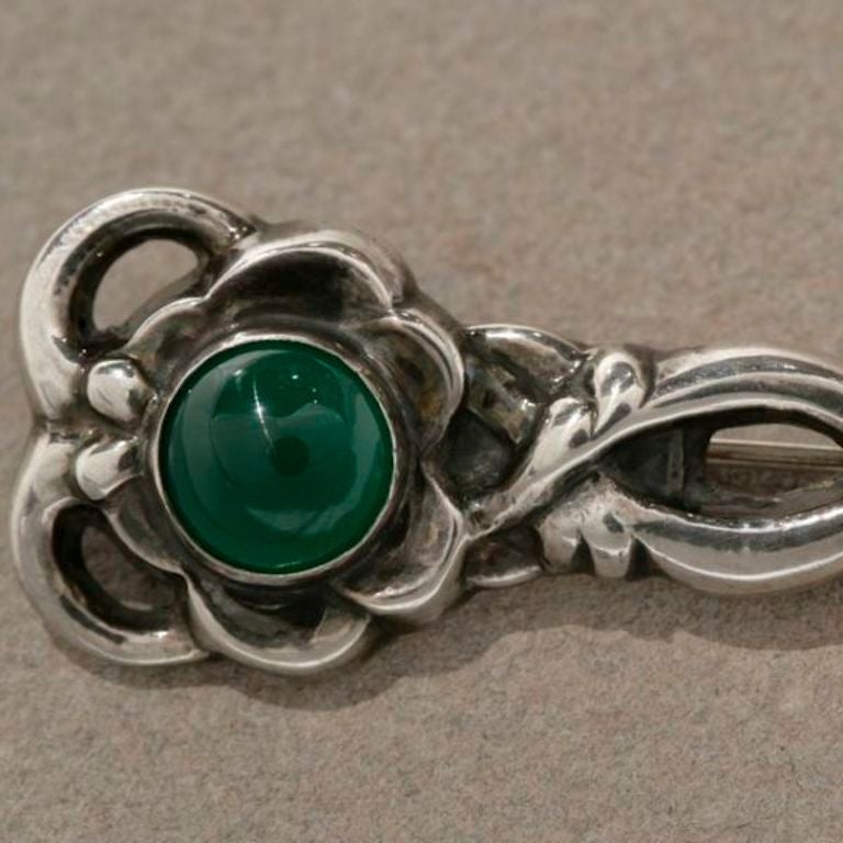 Georg Jensen Sterling Silver Brooch No. 72 with Chrysoprase Cabochon

Early marks with tubular sliding clasp. Circa 1933-22 hallmarks. 

Excellent vintage condition.

Complimentary gift box and FREE shipping included.