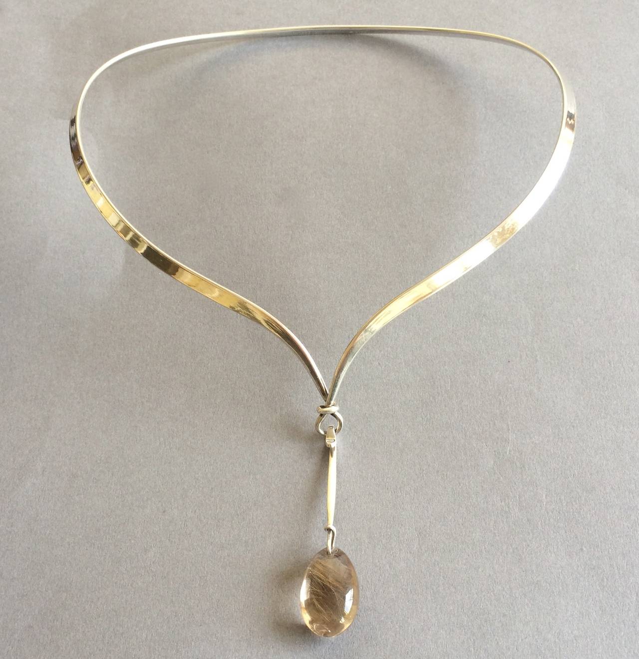 Georg Jensen Neckring, no. 169 with rutilated quartz drop pendant, no. 128 by Vivianna Torun. Interior of neckring measures 5.5