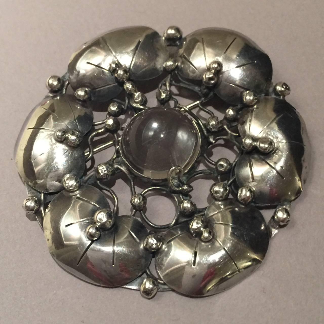 Mary Gage Sterling Silver Brooch with Rock Chrystal Cabochon.

Large brooch in seldom seen design by sought after American Silversmith , Mary Gage. Exquisite detail and rich patina. This sterling silver brooch is in excellent condition.

Dimensions: