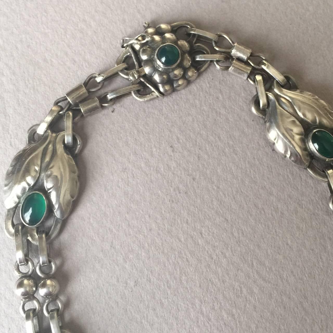 Georg Jensen 830 Silver Necklace No. 1 with Green Chrysoprase.

Designed by Georg Jensen in 1904, this stunning piece has hallmarks from the 1920's.

This necklace is articulated beautifully so that it lays perfectly on the neck and breastbone. It