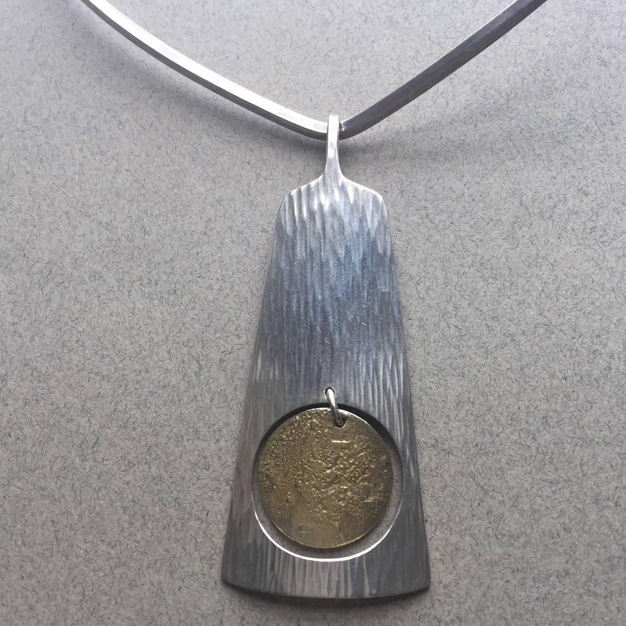 Hans Hansen Sterling Silver Pendant with Gold Vermeil on Sterling Silver Neckring

Interesting bark-like textured surface. Circa 1970s. Excellent condition.

Dimensions: 8.25"L x 5.63"W

Complimentary gift box and FREE shipping