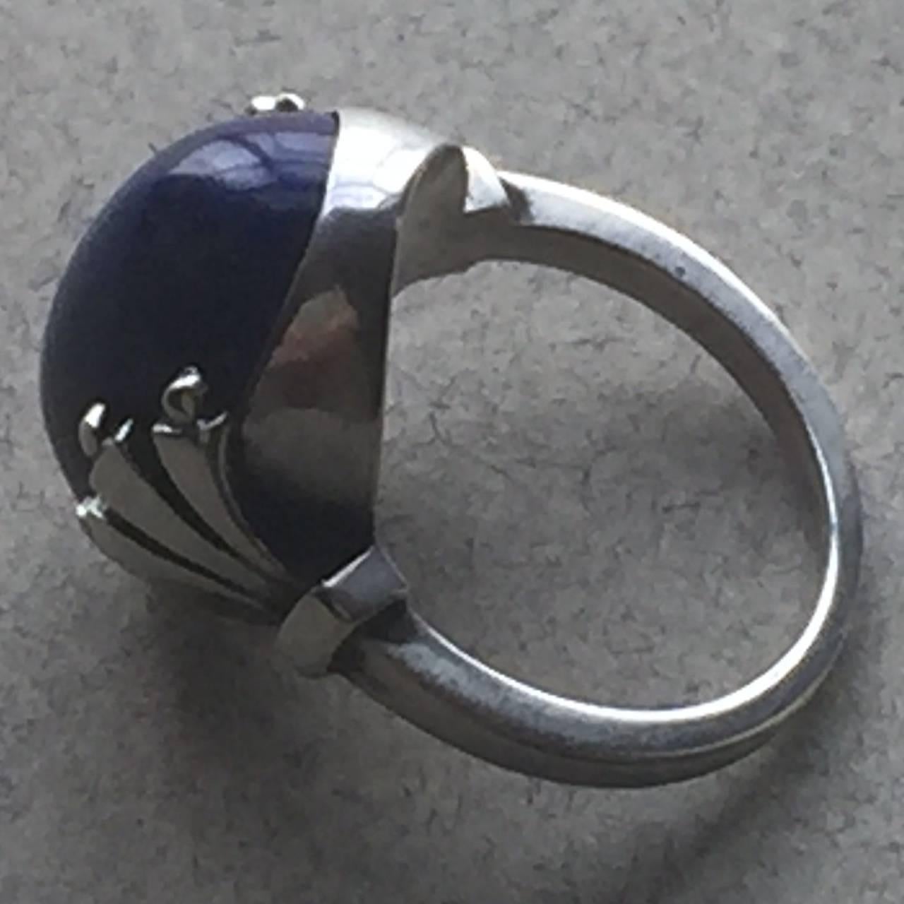 Georg Jensen Sterling Silver Ring No. 51 by Oscar Gundlach-Pedersen.

Beautiful art deco design with a bright and vibrant lapis lazuli gemstone. 

Size 7 ring in excellent condition.

Dimensions: Face of ring - .75