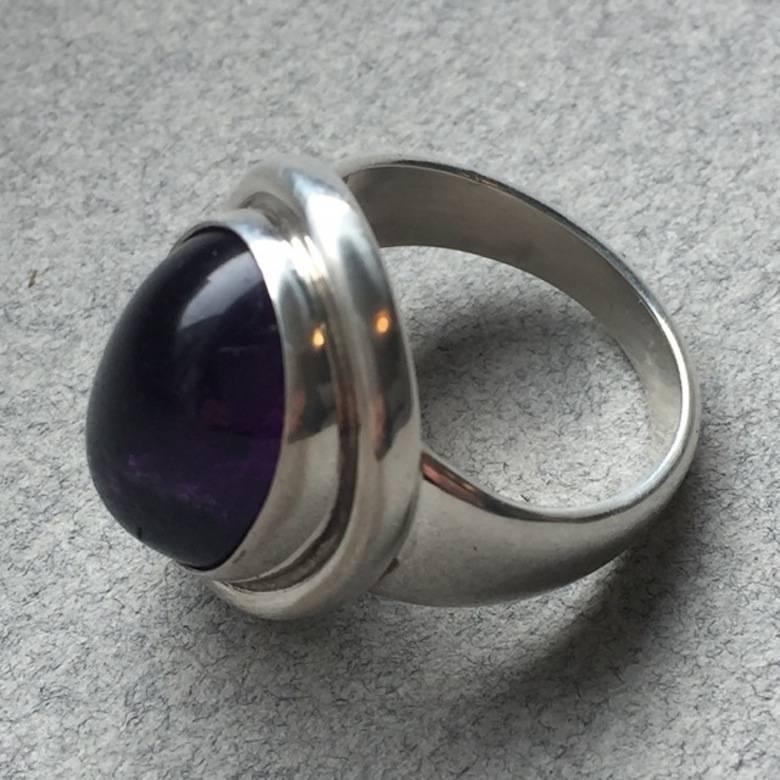 Georg Jensen Sterling Silver Amethyst Cabochon Ring No. 46A by Harald Nielsen

The gemstone has a deep, rich purple color with slight inclusions which is normal for a gemstone of this size. Stunning sterling silver ring in excellent