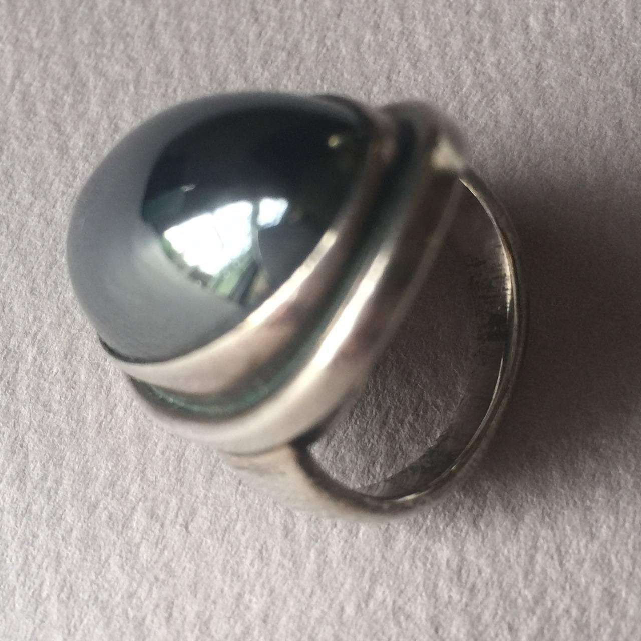 Georg Jensen ring with Hematite Cabochon by Harald Nielsen.

This is the largest size of this design and it can be sized at no charge.

Stunning ring in excellent condition.

Complimentary gift box and FREE shipping included.

About the