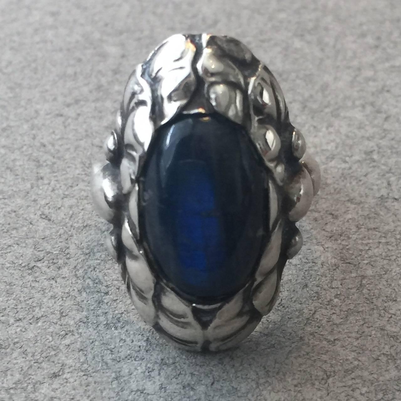 Georg Jensen Sterling Silver Ring No. 11 With Labradorite.

A wonderful ring that is rare to see in this large size and with Labradorite. The gem quality stone has a gorgeous iridescent quality and is surrounded by highly detailed sterling silver