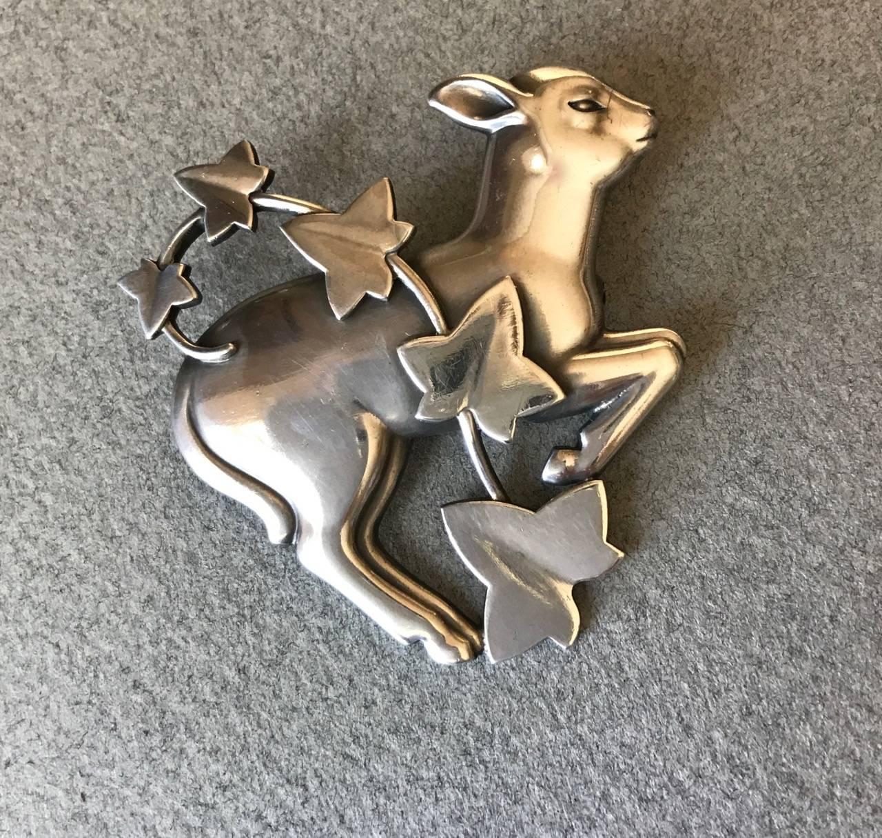 Georg Jensen Sterling Silver Lamb and Ivy Brooch No. 311 by Arno Malinowski

Highly sought-after design, rarely seen. Beautiful, original condition.

Complimentary gift box and FREE shipping included. 

About the designer:
Arno Malinowski