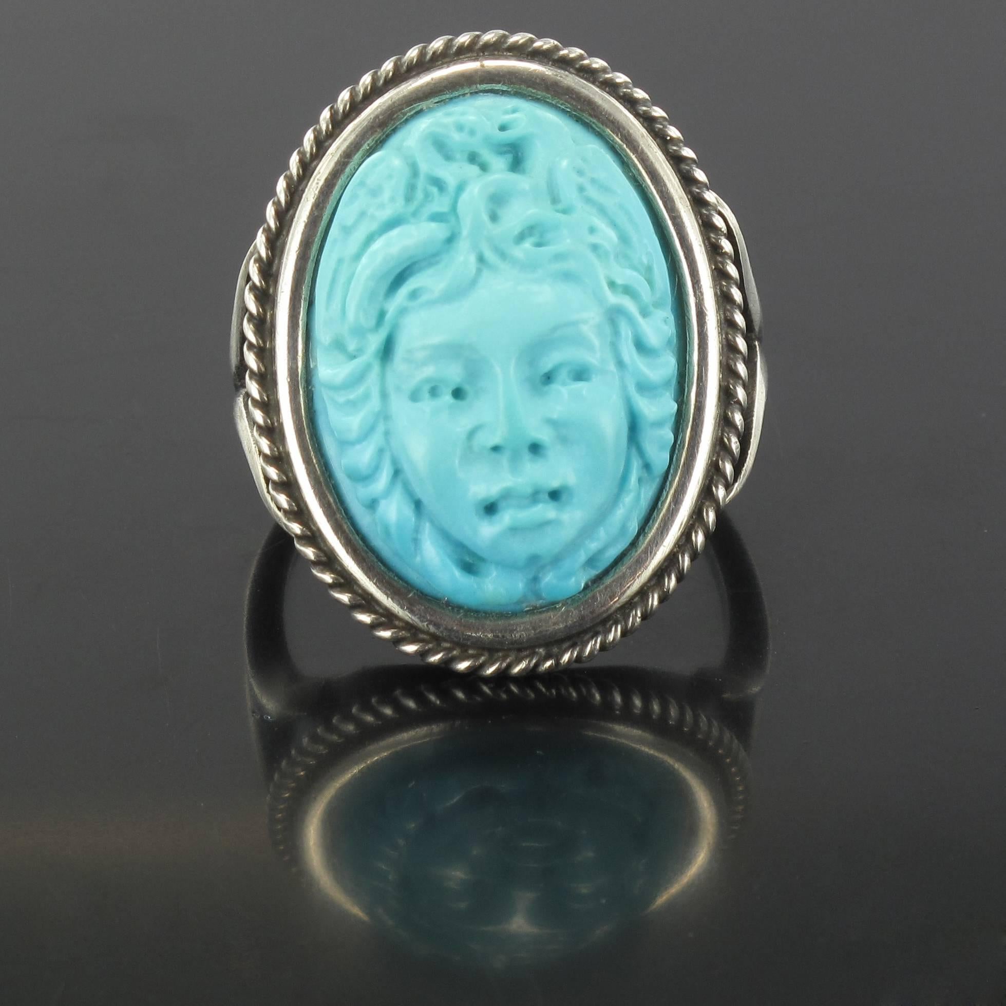 Silver Ring.

This splendid antique silver ring is bezel set with a turquoise cameo of Medusa. The entire edging of the ring mount is set with a fine silver cord. 

Height: 2.6 cm, width: 2 cm, the ring base width: 1.8 mm.
Total weight: about
