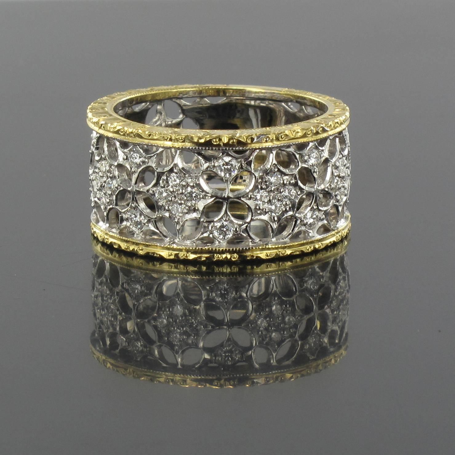 Ring in 18 carat yellow and white gold. 

This wide diamond ring features white gold filigree set with small brilliant cut diamonds edged with yellow gold filigree band. 

Total diamond weight: about 0.36 carat.
Total weight: about 7.6 g.
US