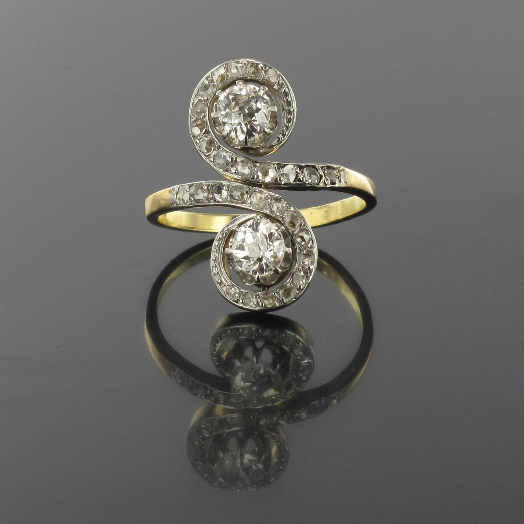 Ring in platinium and 18 carat yellow gold, owl and grotesque hallmarks. 

This splendid Lovers Ring is claw set with 2 antique cut diamonds within the form of a letter ‘S’ set with rose cut diamonds reaching to the beginning of the ring band.