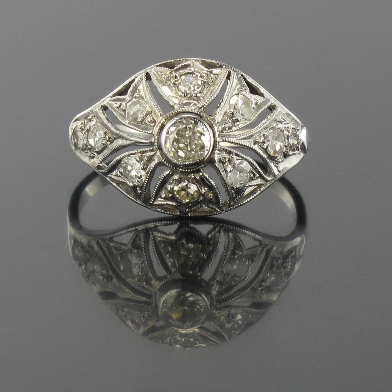 Ring in platinum and18 carat white gold, eagle head hallmark. 

This stunning antique ring is shaped in the form of an openwork beaded dome. It is bezel set with small rose cut diamonds and a bezel set beaded brilliant cut round diamond at the