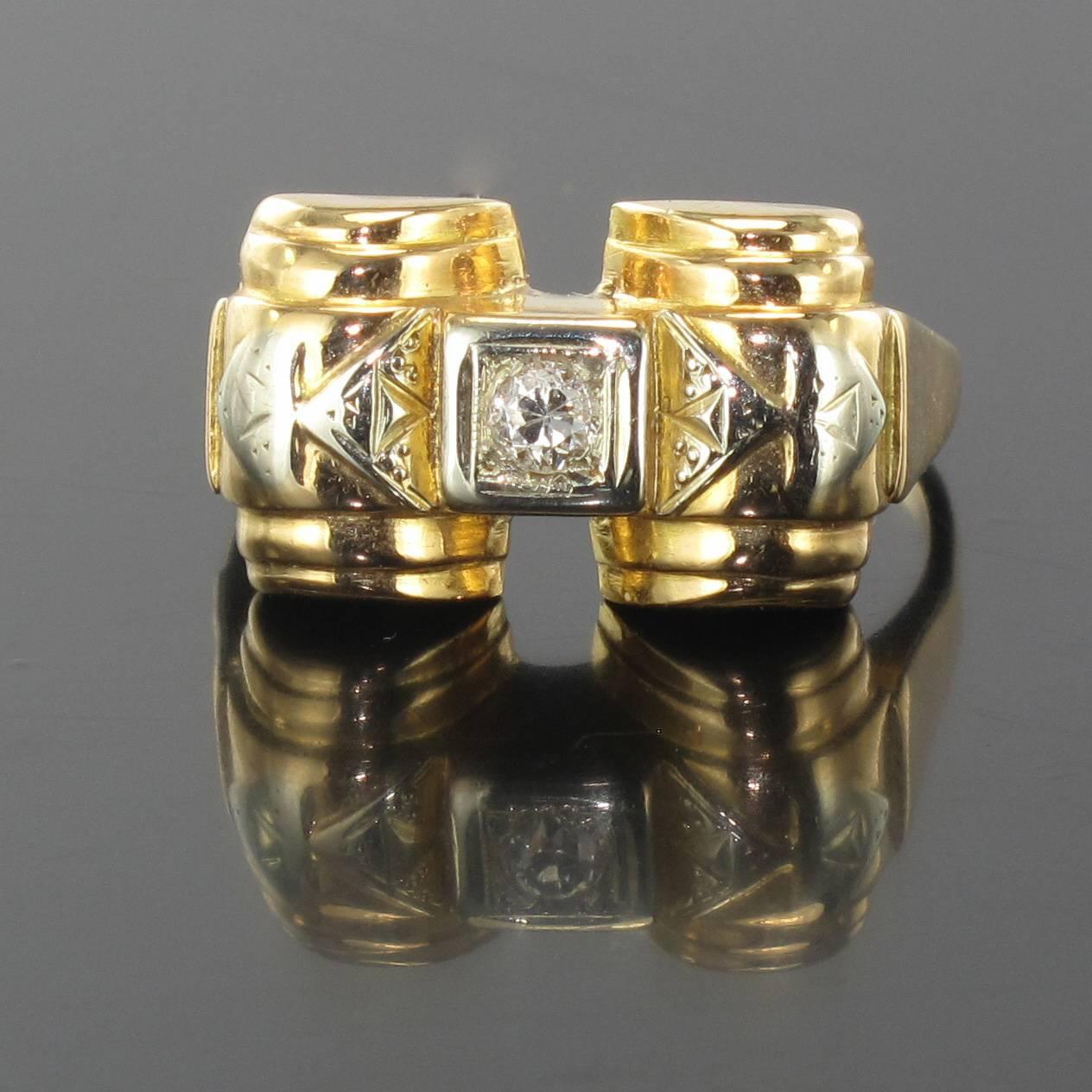 Ring in 18 carat yellow gold. 

This bridge ring features a central brilliant cut diamond set within a square design between two half cylinders. 

Height : 9.7 mm, width; 1.75 cm, height on the finger; 4.5 mm, band width at the base: 1.5 mm