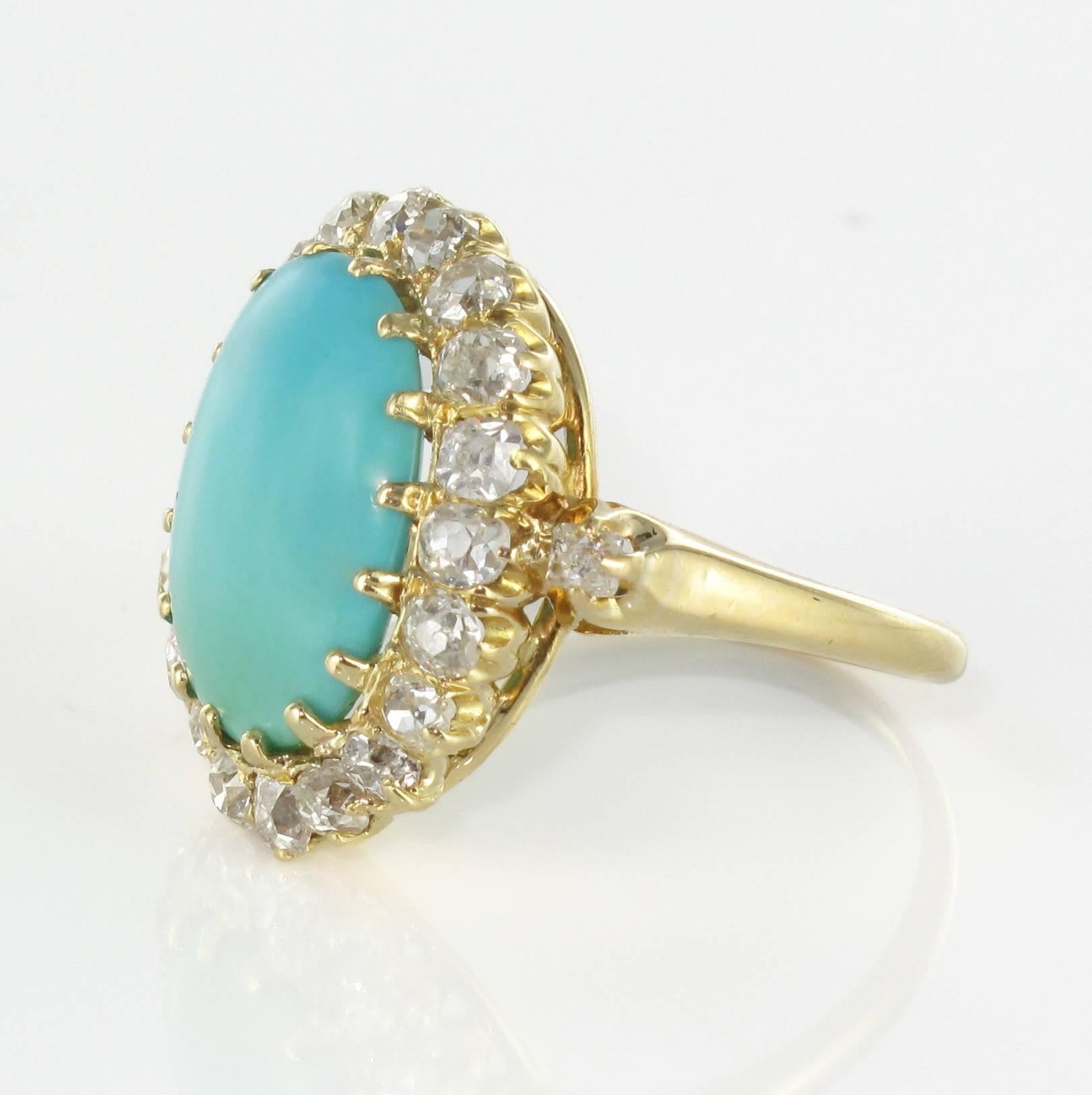 Ring in 18 carat yellow gold. 

This magnificent antique ring is claw set with a central turquoise cabochon surrounded by 20 perfectly matched antique cut diamonds. 
On each side, another antique cut diamond is also set into the beginning of the