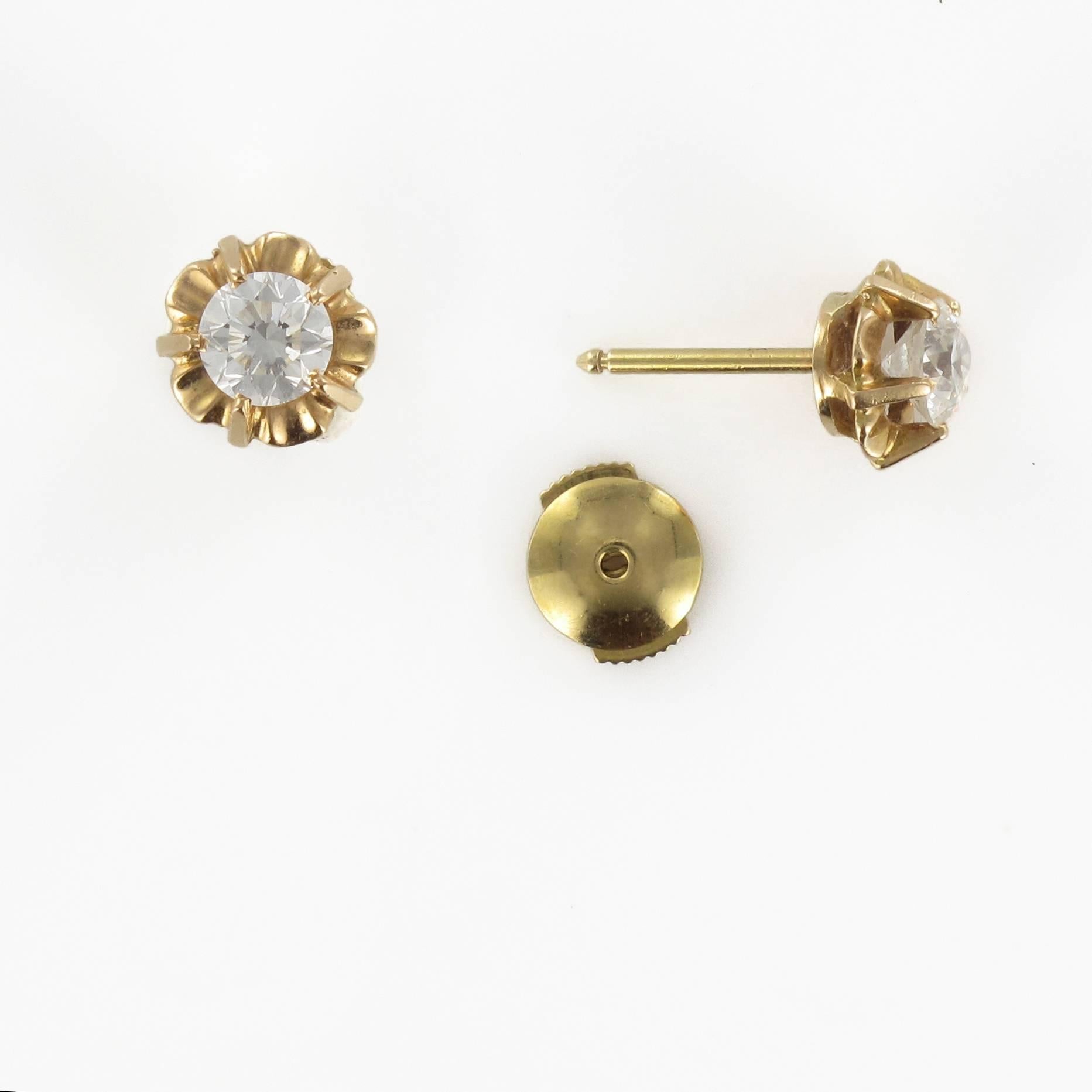 Earrings in 18 carat yellow gold. 

These superb earring studs are different to the typical style stud earrings. These are composed of radiant white brilliant cut diamonds claw set in a ‘Sun’ style setting which enhances the size and brilliance of