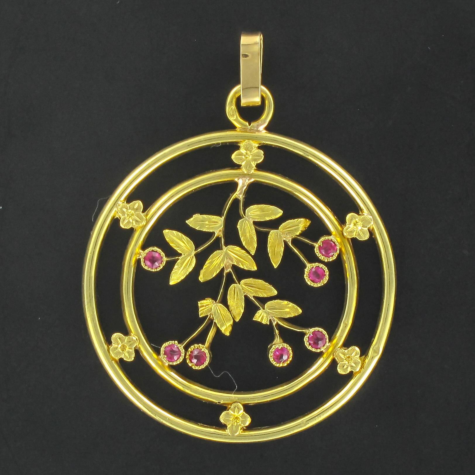 Pendant in 18 carat yellow gold, eagle head hallmark. 
This magnificent antique pendant necklace is composed of gold strands connected by small flower motifs. At the centre is an engraved leafy design that is beaded and bezel set with small round