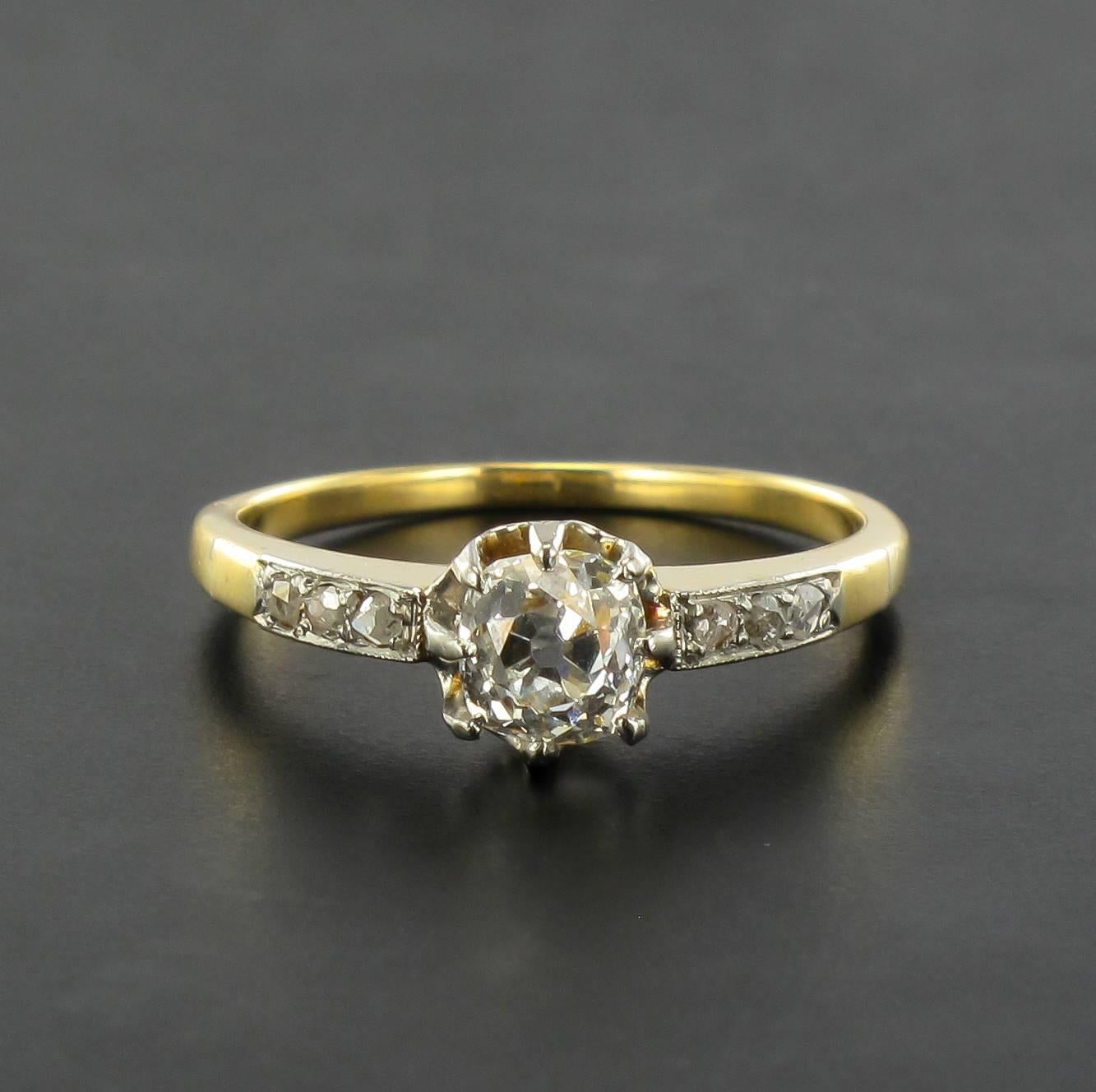 Ring in 18 carat yellow gold, eagle head hallmark. 

This fabulous antique ring is claw set with an antique cushion cut diamond with 3 rose cut diamonds at the beginning of the ring band. 

Weight of the central diamond: about .90 carat.