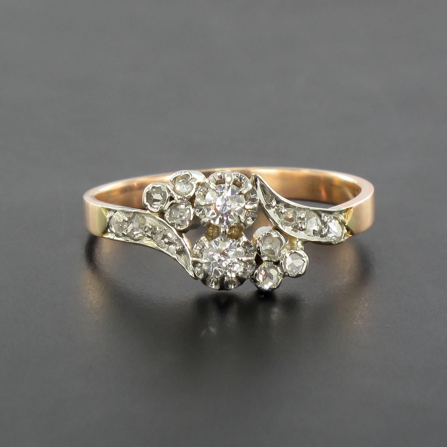 Ring in 18 carat rose gold, eagle head hallmark. 

This splendid antique ring is set with 2 brilliant cut diamonds accentuated by a clover shape on each side each set with 3 rose cut diamonds. 3 more rose cut diamonds enhance the beginning of the